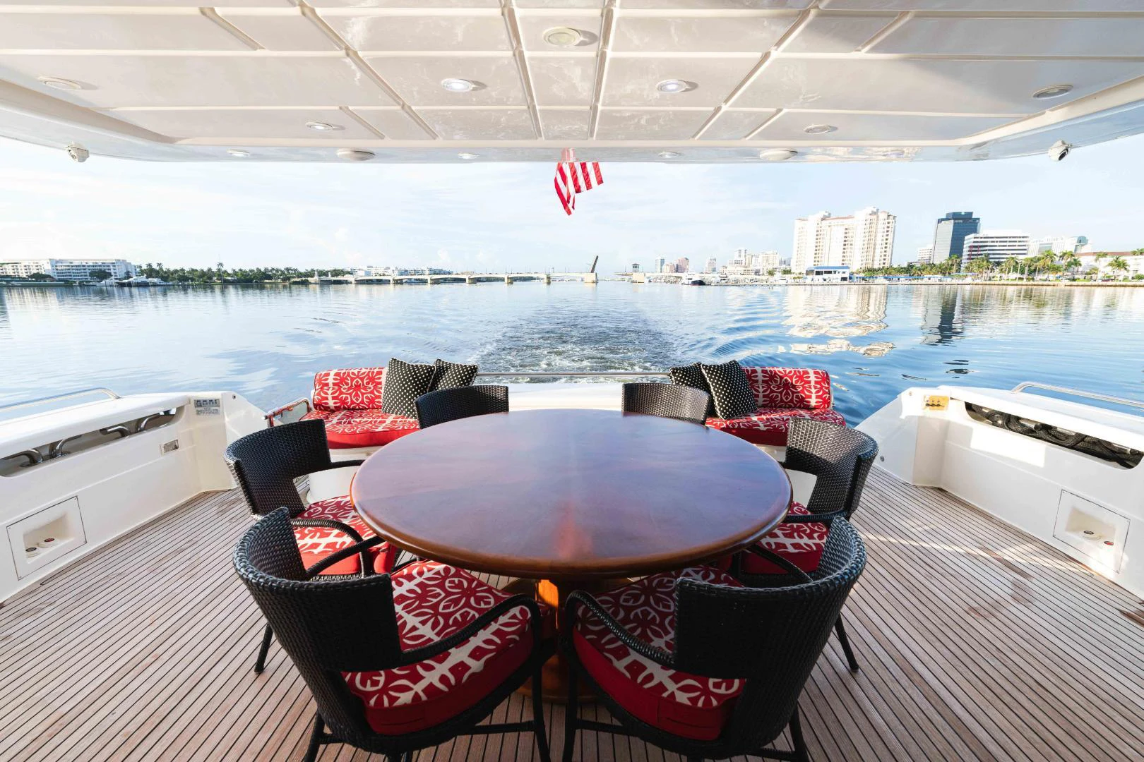 a table and chairs on a deck overlooking a body of water aboard KAVITA Yacht for Sale