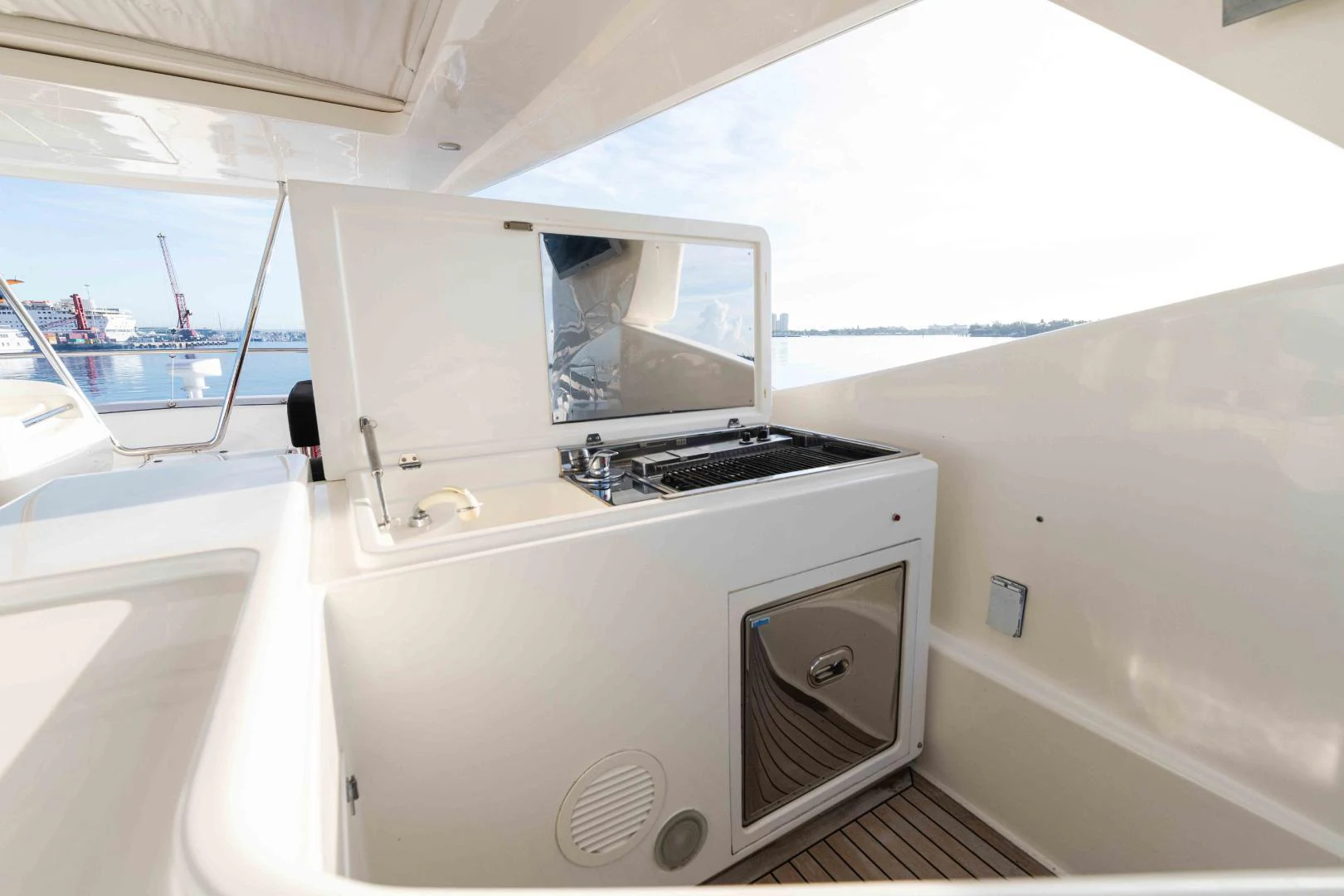 a white kitchen with a sink aboard KAVITA Yacht for Sale