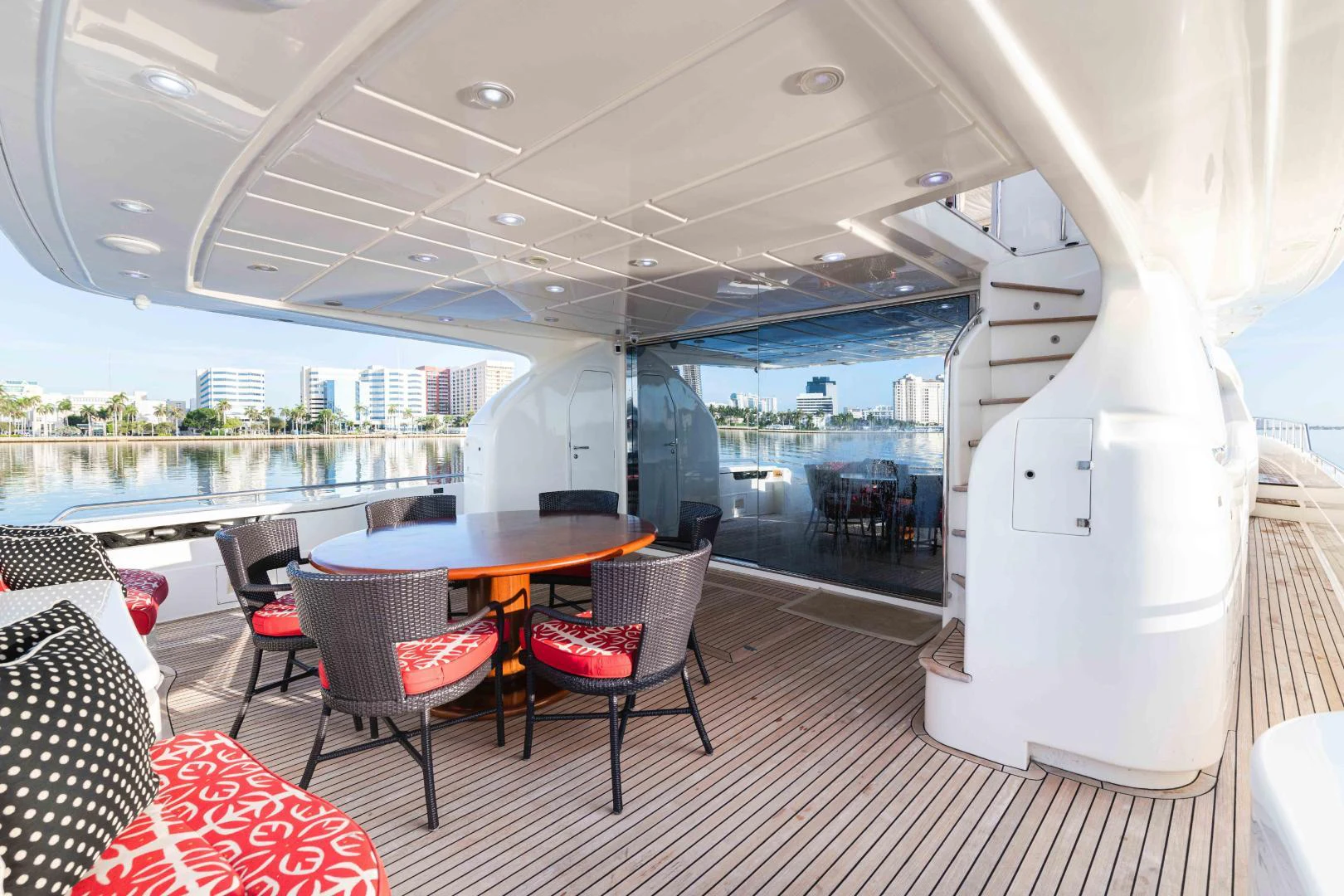 a white table and chairs on a deck with a view of the water aboard KAVITA Yacht for Sale