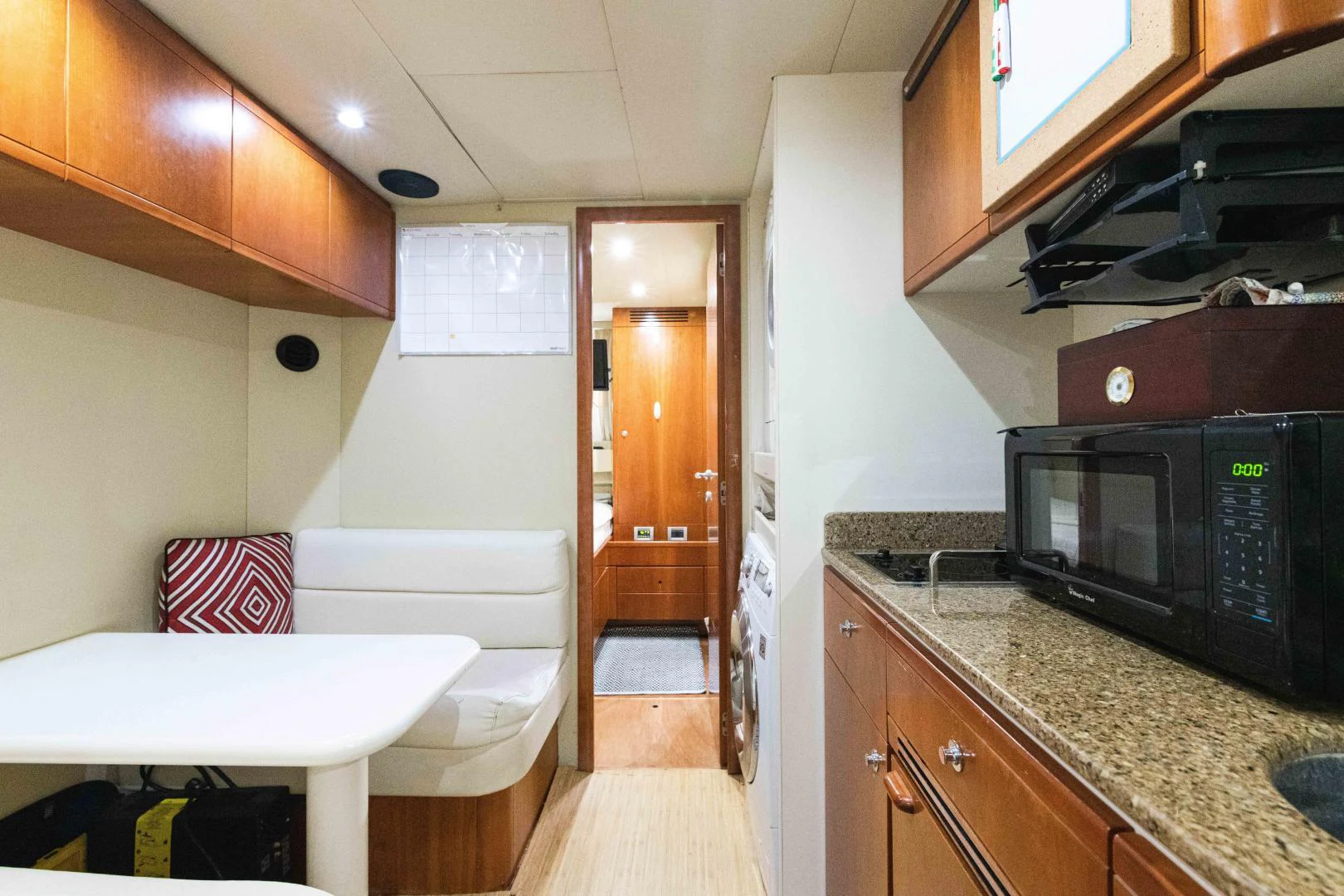 a kitchen with a microwave oven and a table aboard KAVITA Yacht for Sale