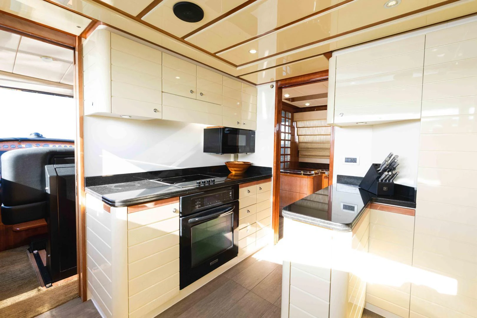 a kitchen with white cabinets aboard KAVITA Yacht for Sale