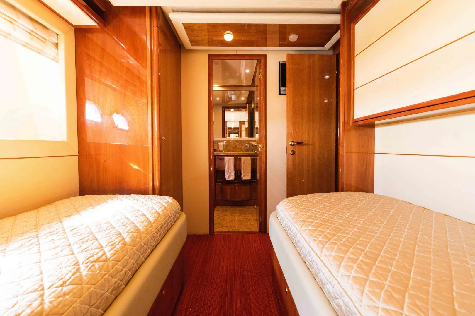 a room with a bed and a mirror aboard KAVITA Yacht for Sale