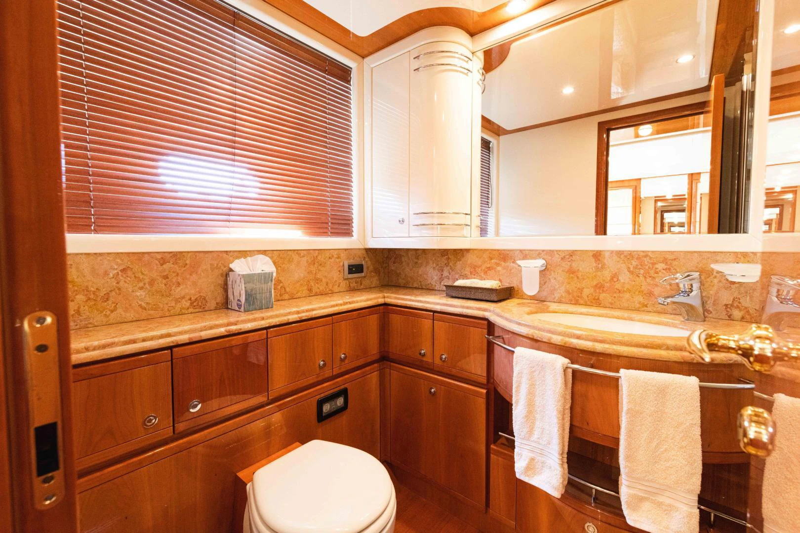 a bathroom with wooden cabinets aboard KAVITA Yacht for Sale