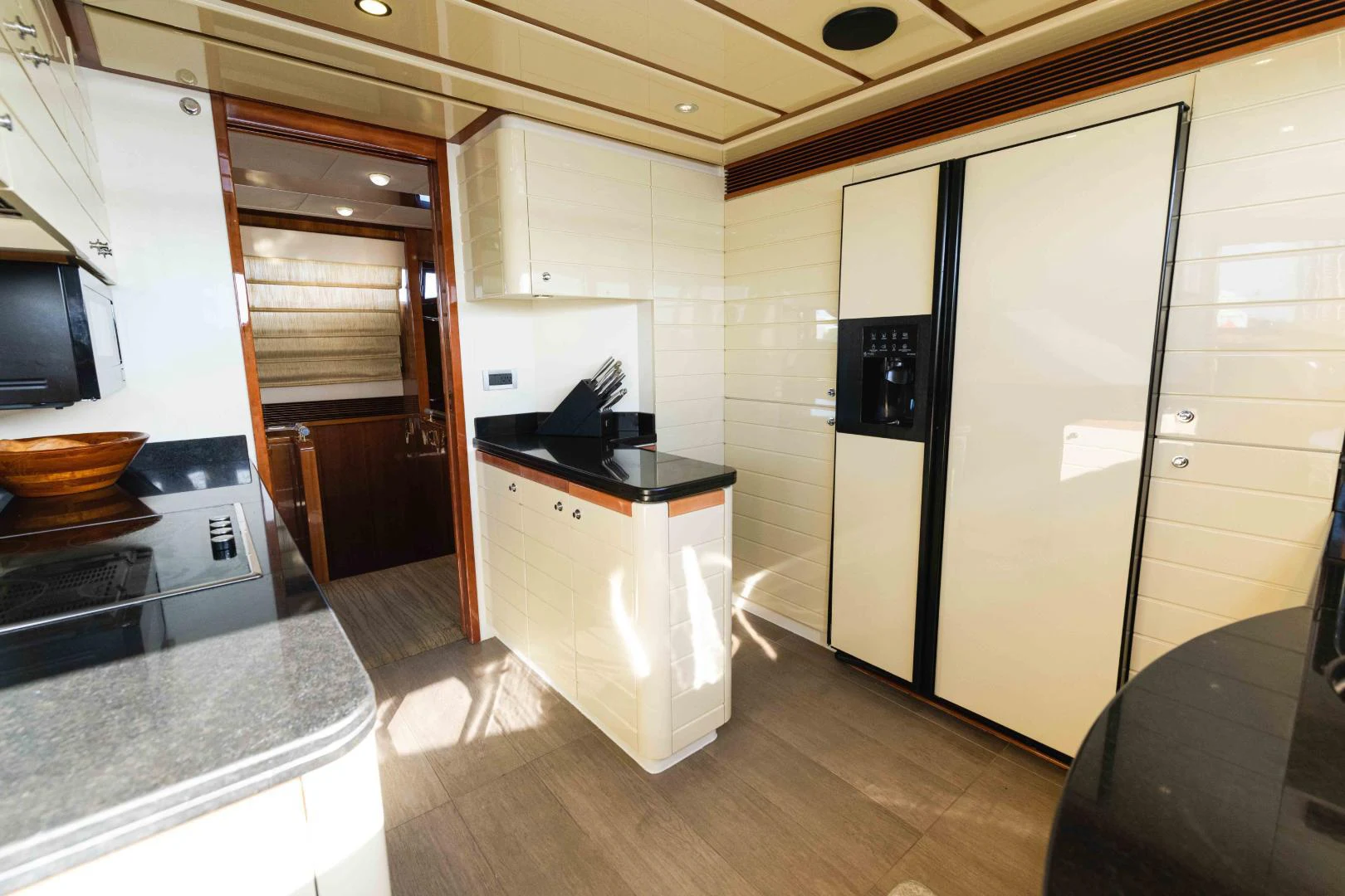 a kitchen with a large refrigerator aboard KAVITA Yacht for Sale