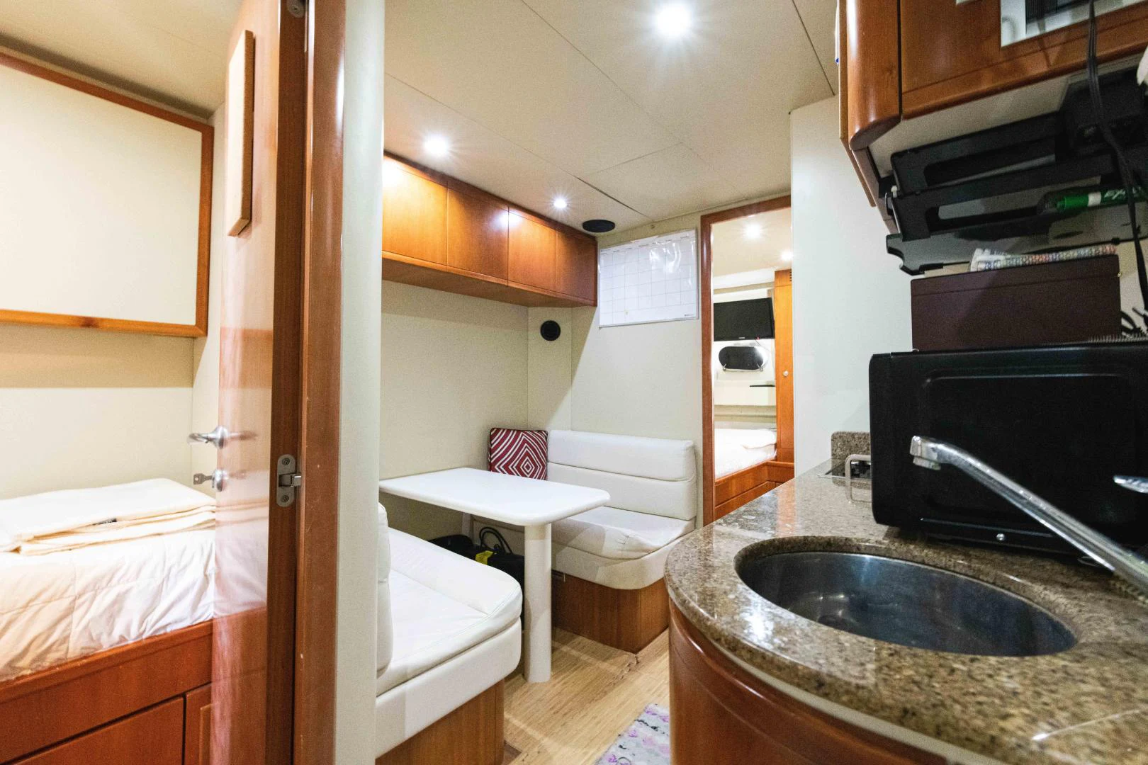 a bathroom with a sink and a bed aboard KAVITA Yacht for Sale