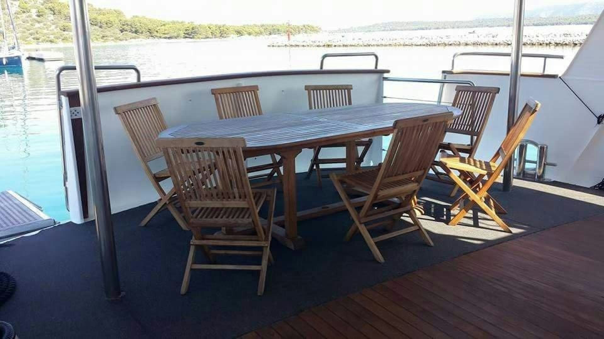 a table on a deck aboard EVA Yacht for Sale