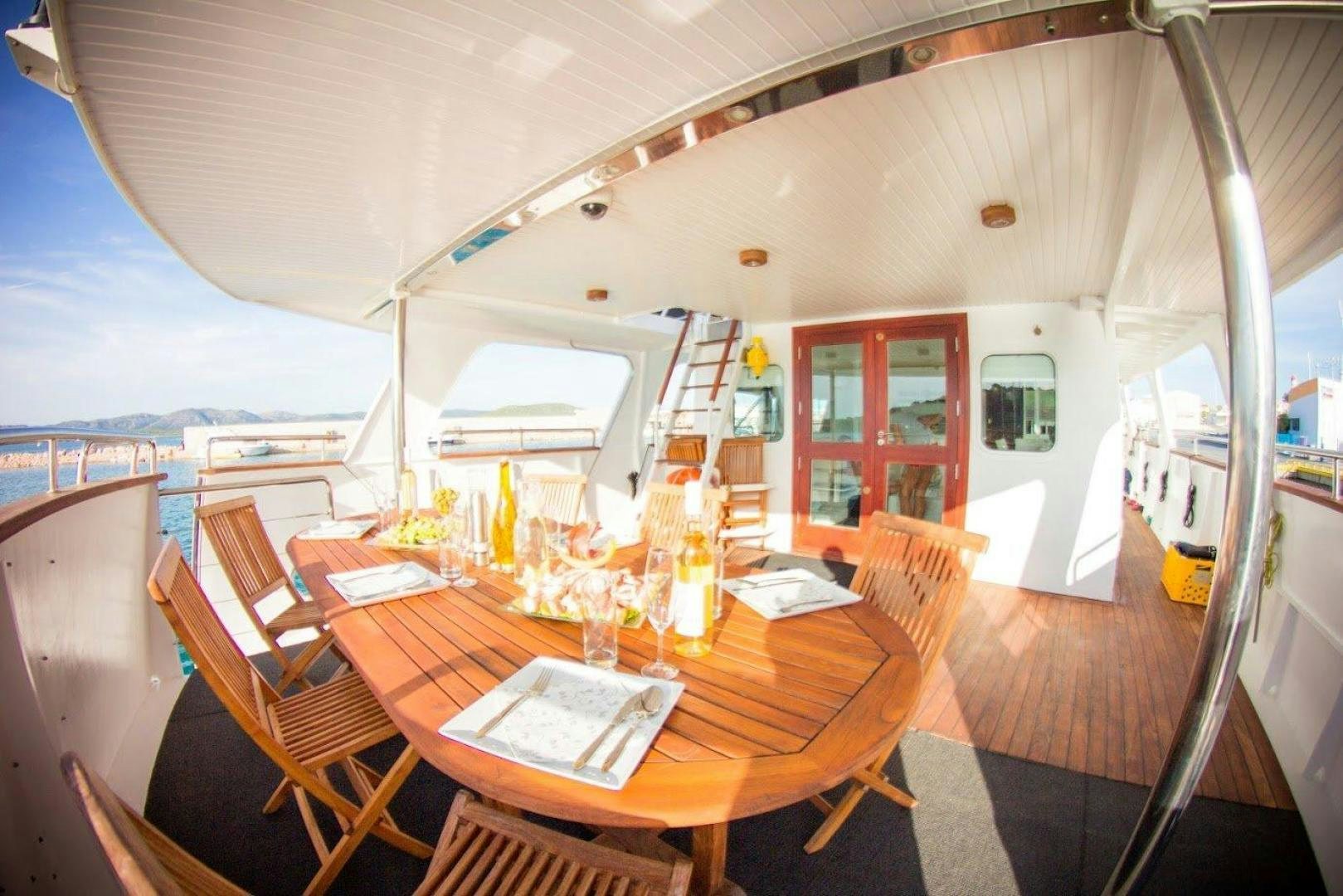 a dining room with a table and chairs aboard EVA Yacht for Sale