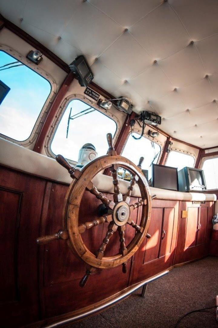 a large wooden wheel aboard EVA Yacht for Sale