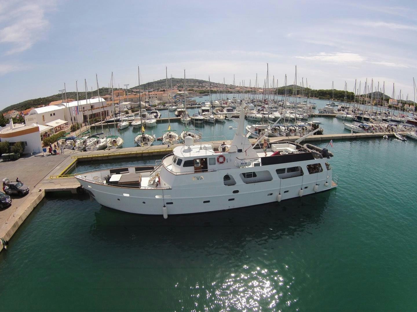 a large white boat sits in the water aboard EVA Yacht for Sale