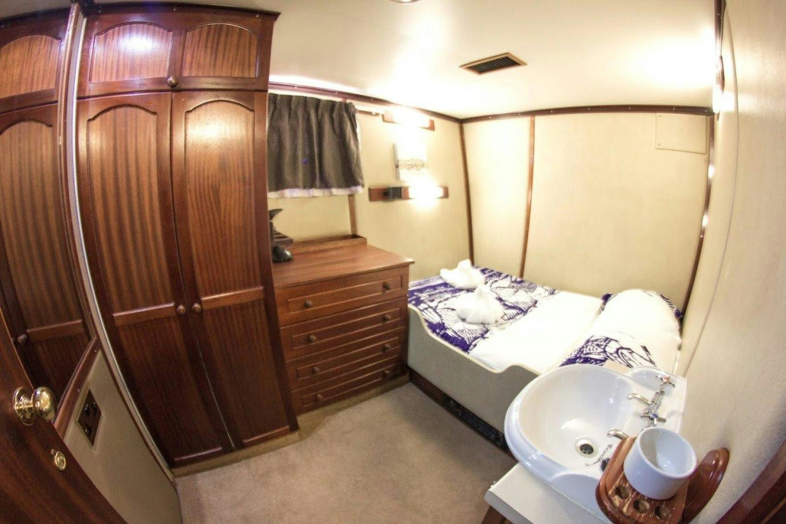 a bathroom with a sink and a bed aboard EVA Yacht for Sale