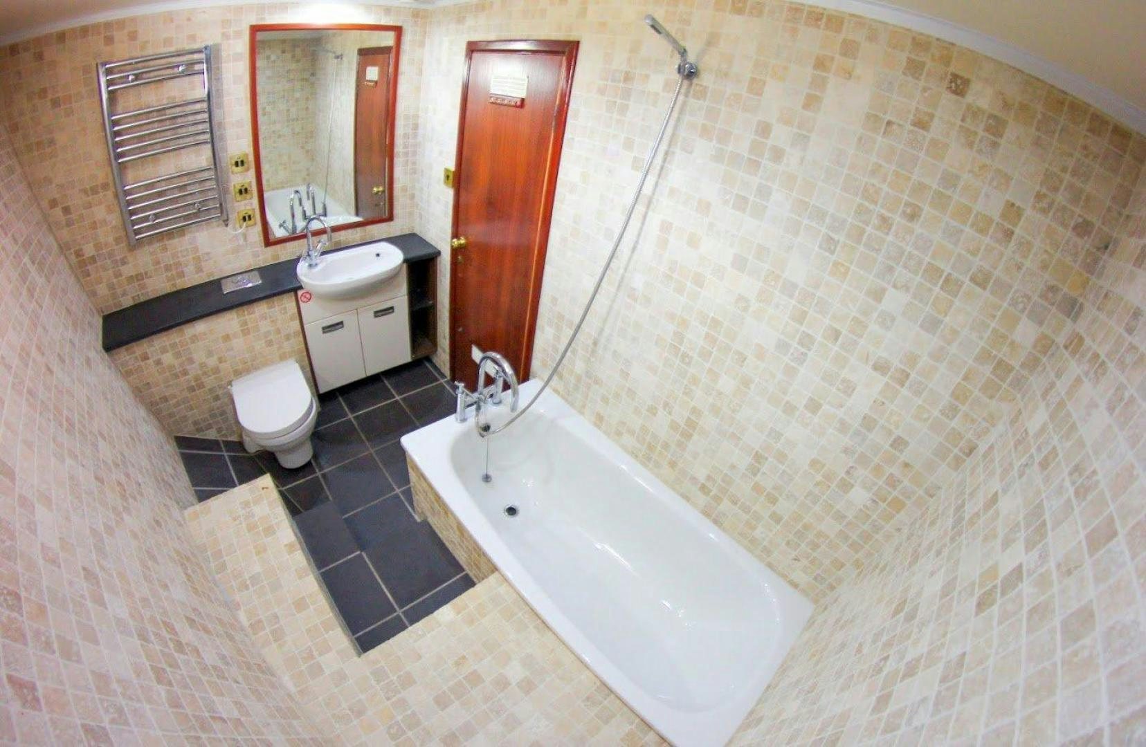 a bathroom with a tub toilet and sink aboard EVA Yacht for Sale