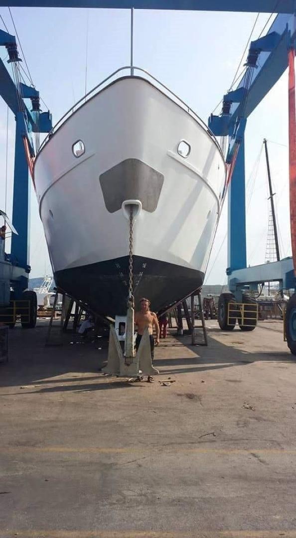 a person standing next to a large airplane aboard EVA Yacht for Sale