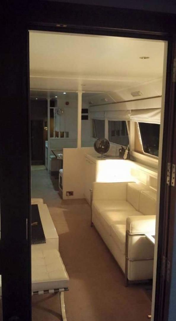 a room with a couch and a mirror aboard EVA Yacht for Sale