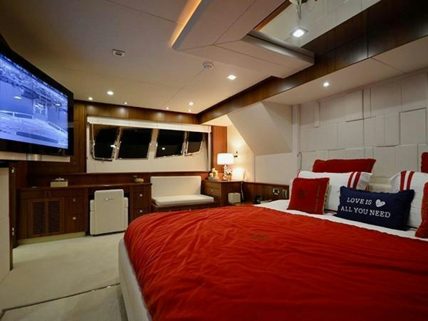 a bedroom with a bed and a tv aboard EXIMIUS Yacht for Sale