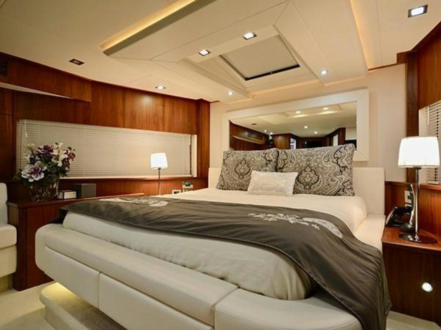 a bedroom with a bed and a desk aboard EXIMIUS Yacht for Sale