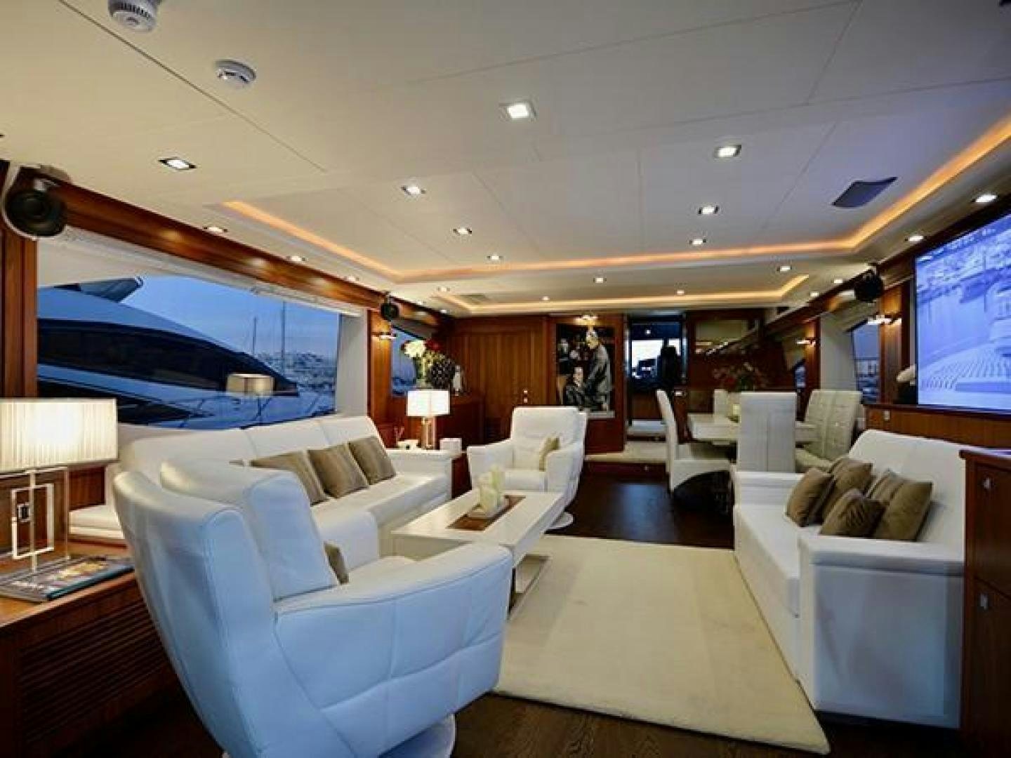 a living room with a large screen aboard EXIMIUS Yacht for Sale