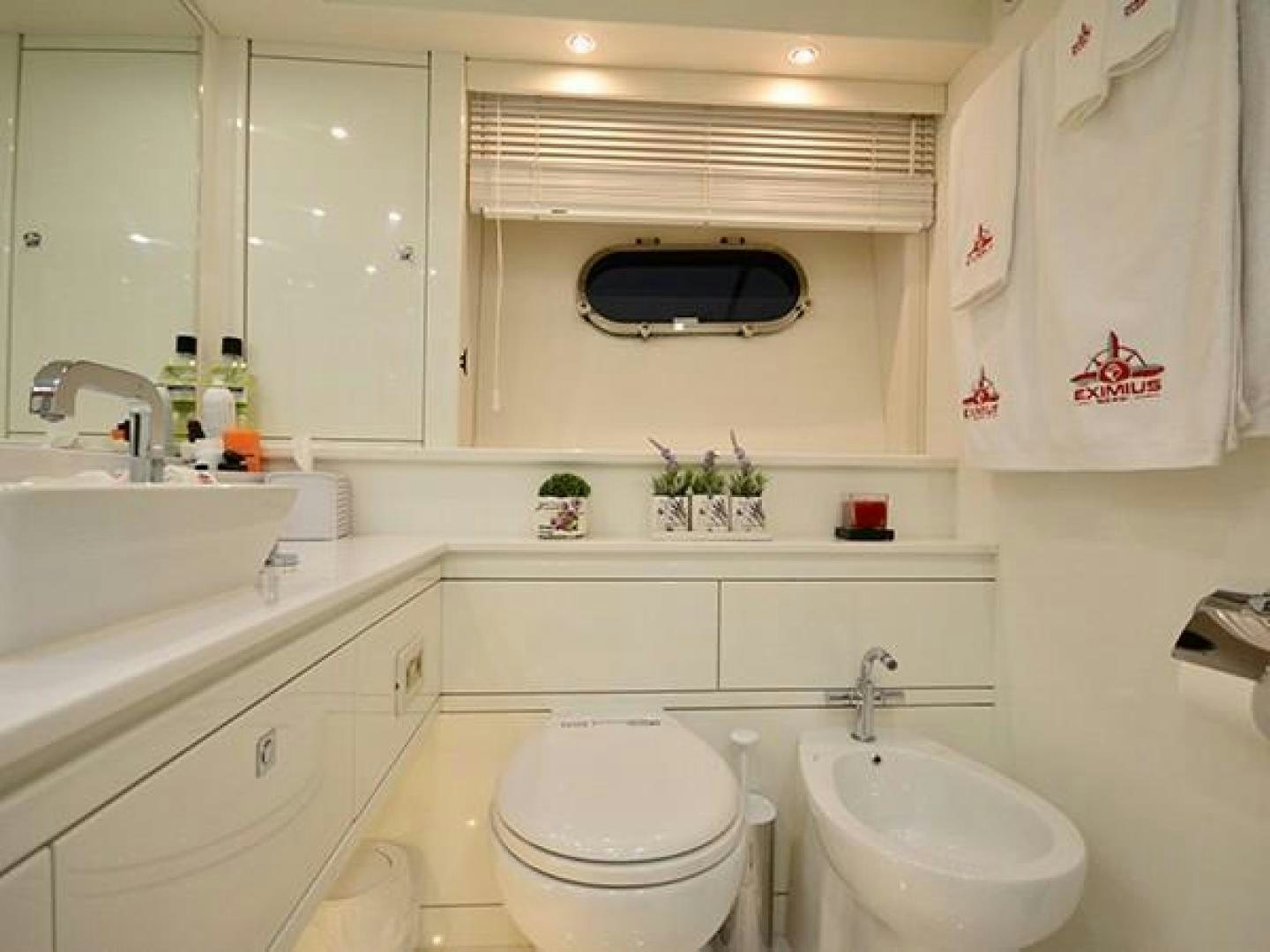 a bathroom with a sink toilet and a bathtub aboard EXIMIUS Yacht for Sale