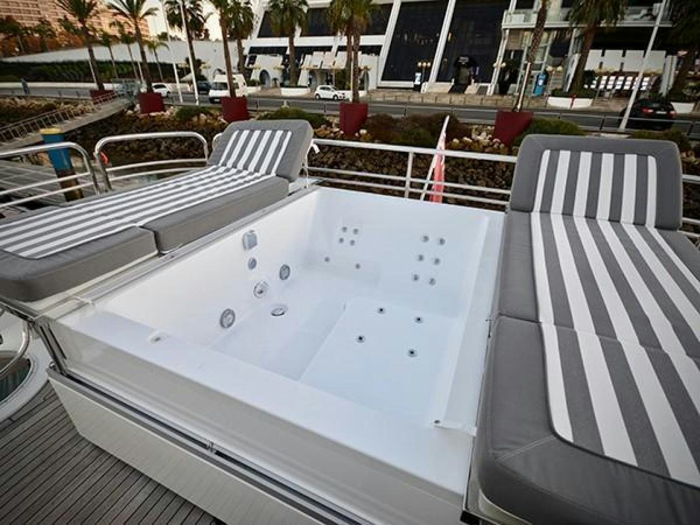 a white pool with a white chair and a white chair on the side aboard EXIMIUS Yacht for Sale
