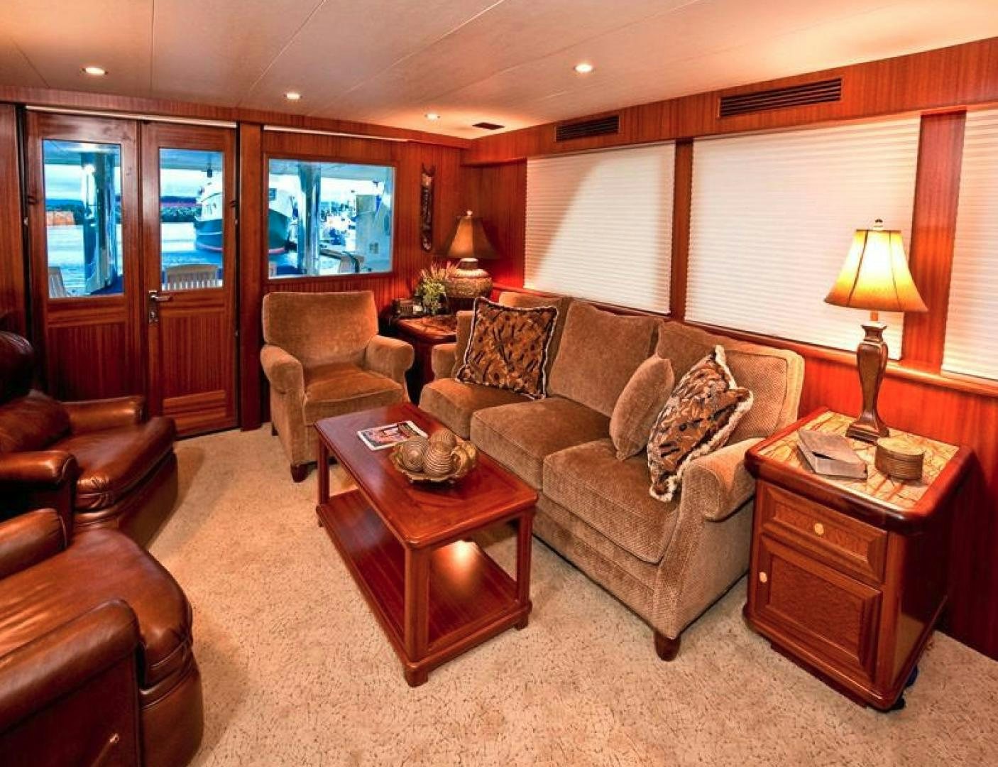 a living room with a leather couch and a wood coffee table aboard NO NAME Yacht for Sale