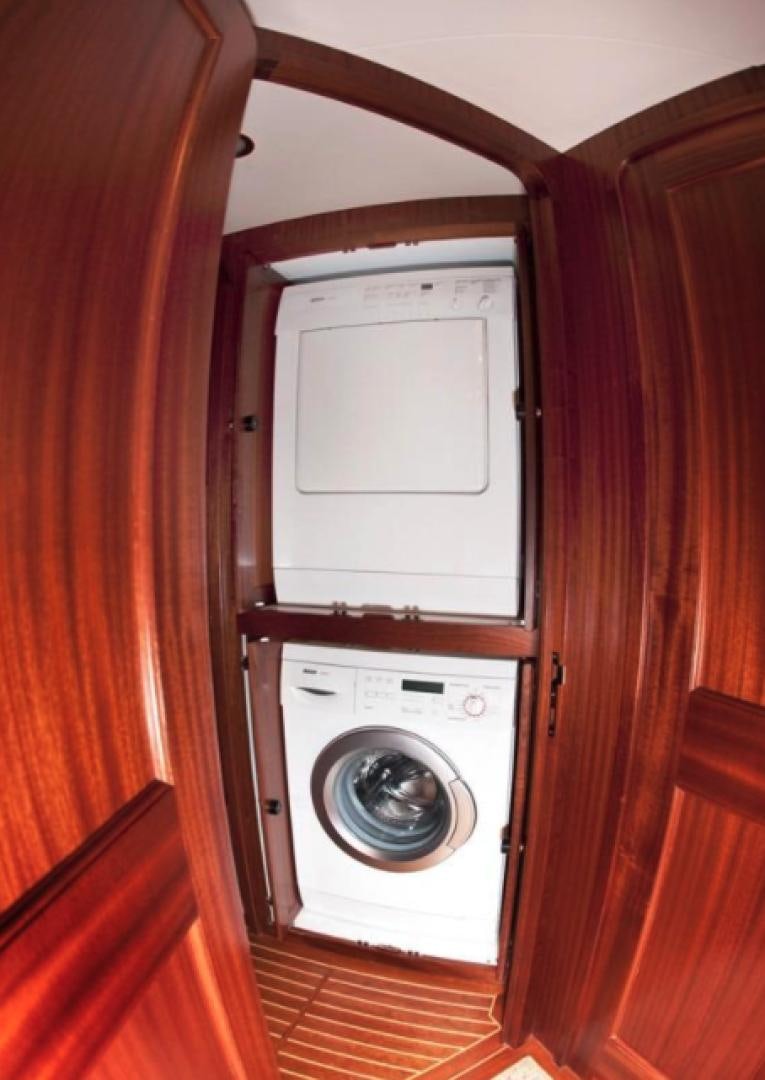 a white washing machine in a wooden room aboard NO NAME Yacht for Sale