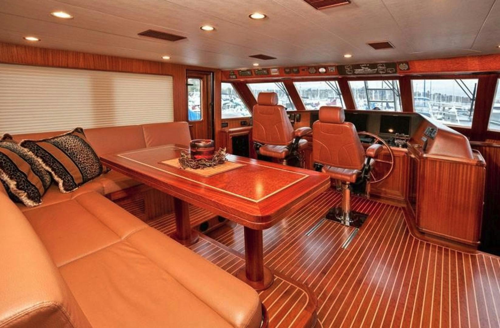 a large living room with a table and chairs aboard NO NAME Yacht for Sale