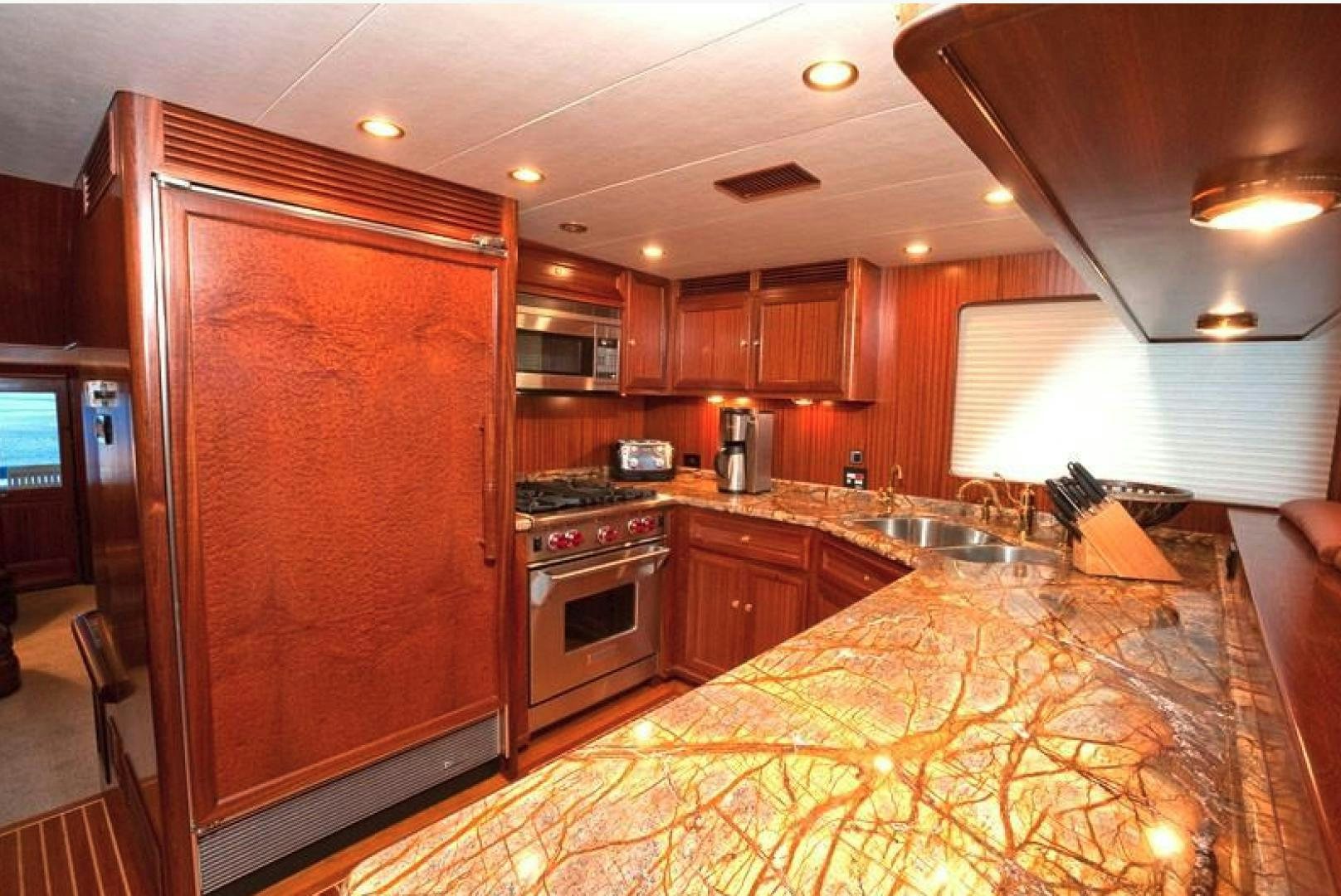 a kitchen with wooden cabinets aboard NO NAME Yacht for Sale