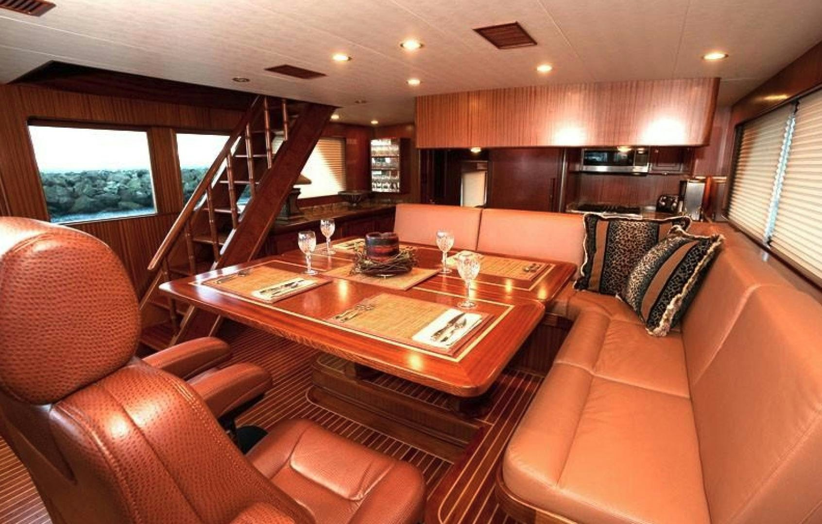 a living room with a table and couches aboard NO NAME Yacht for Sale