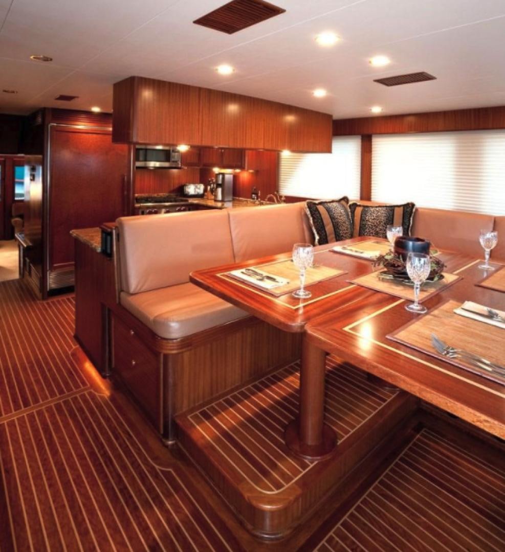 a living room with a table and couches aboard NO NAME Yacht for Sale