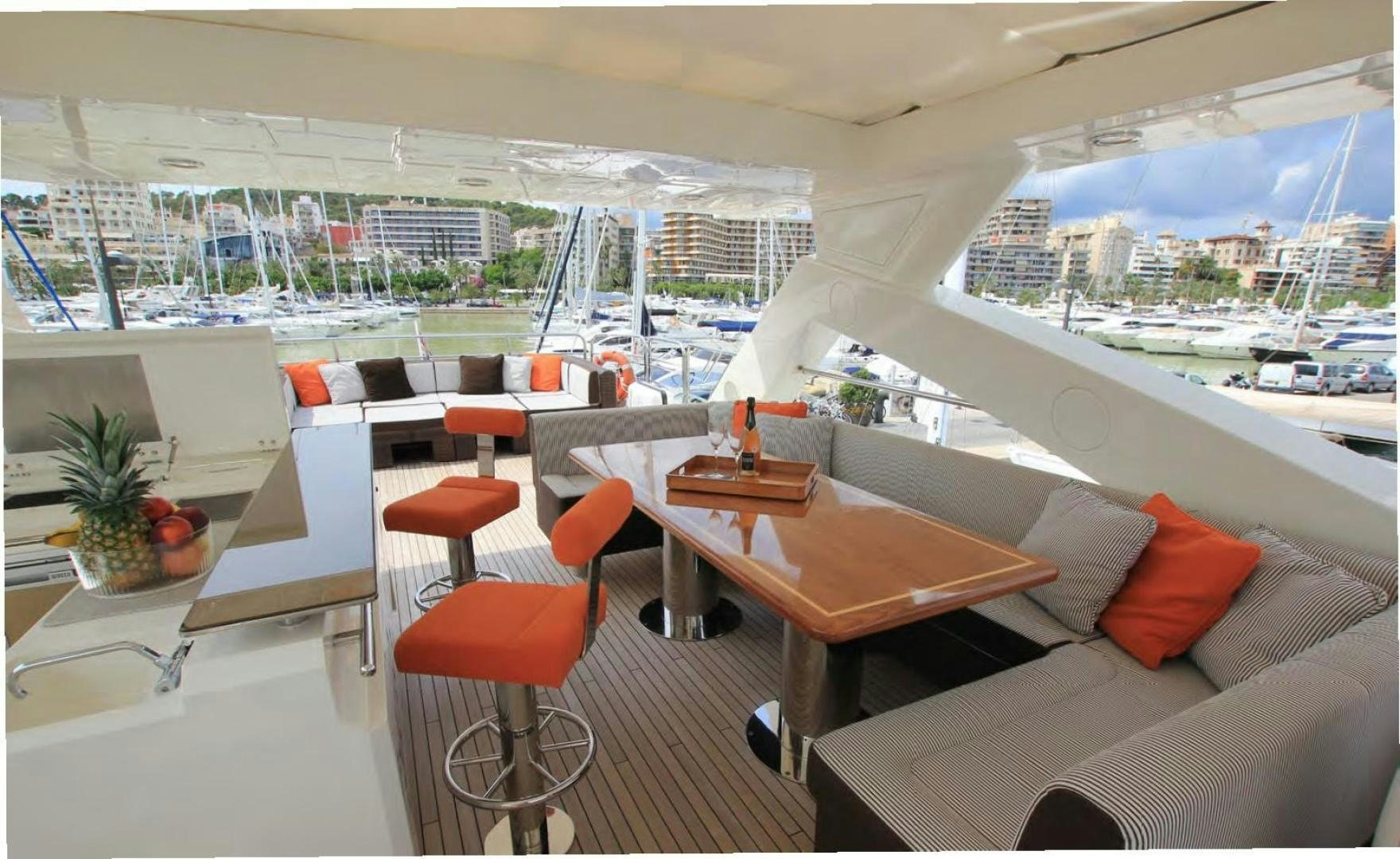 a room with a couch and a table with chairs and a table aboard ANNABEL Yacht for Sale