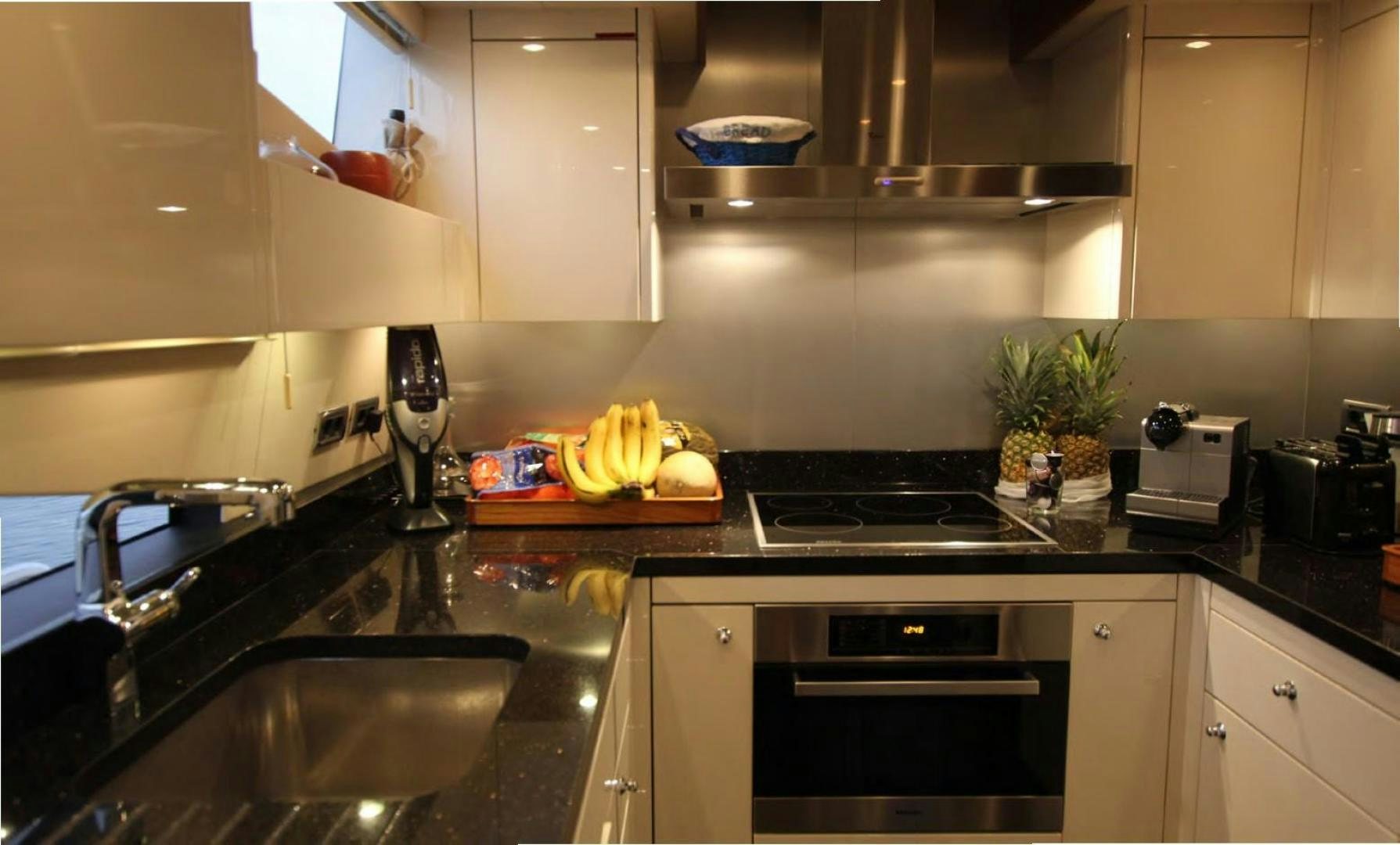 a kitchen with black counters aboard ANNABEL Yacht for Sale