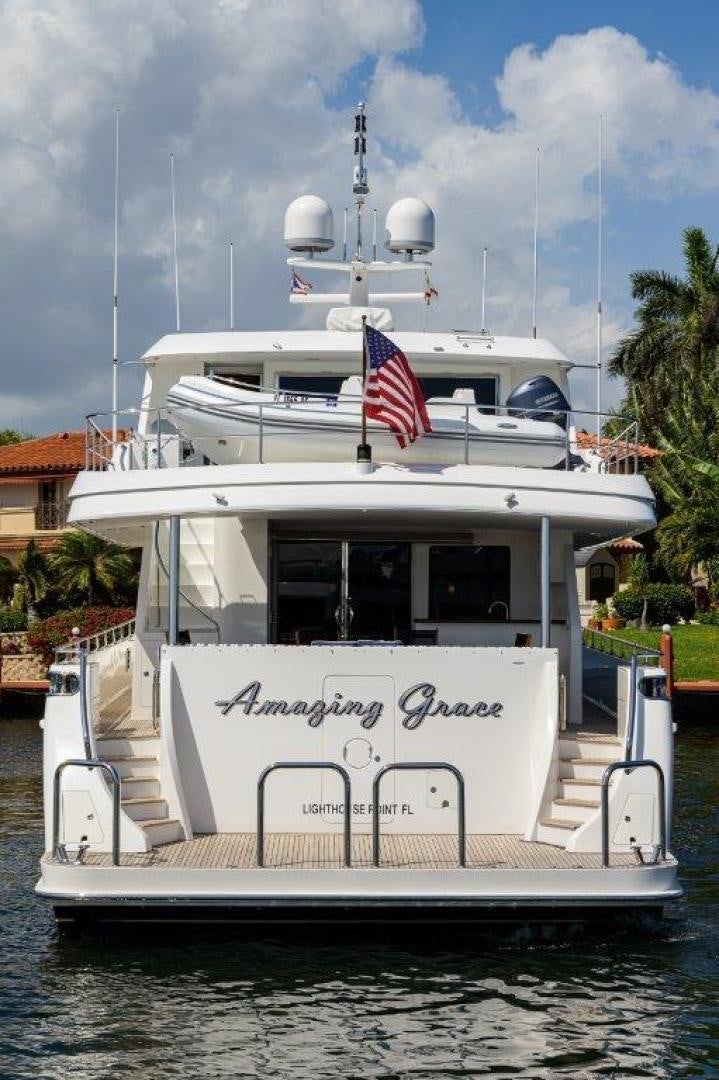 a boat with a flag on the front aboard AMAZING GRACE Yacht for Sale