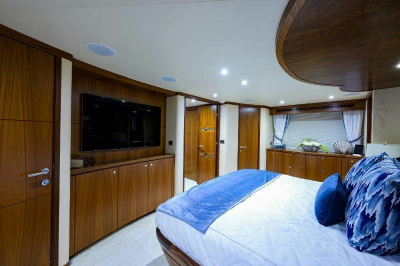 a bedroom with a bed and a television aboard AMAZING GRACE Yacht for Sale