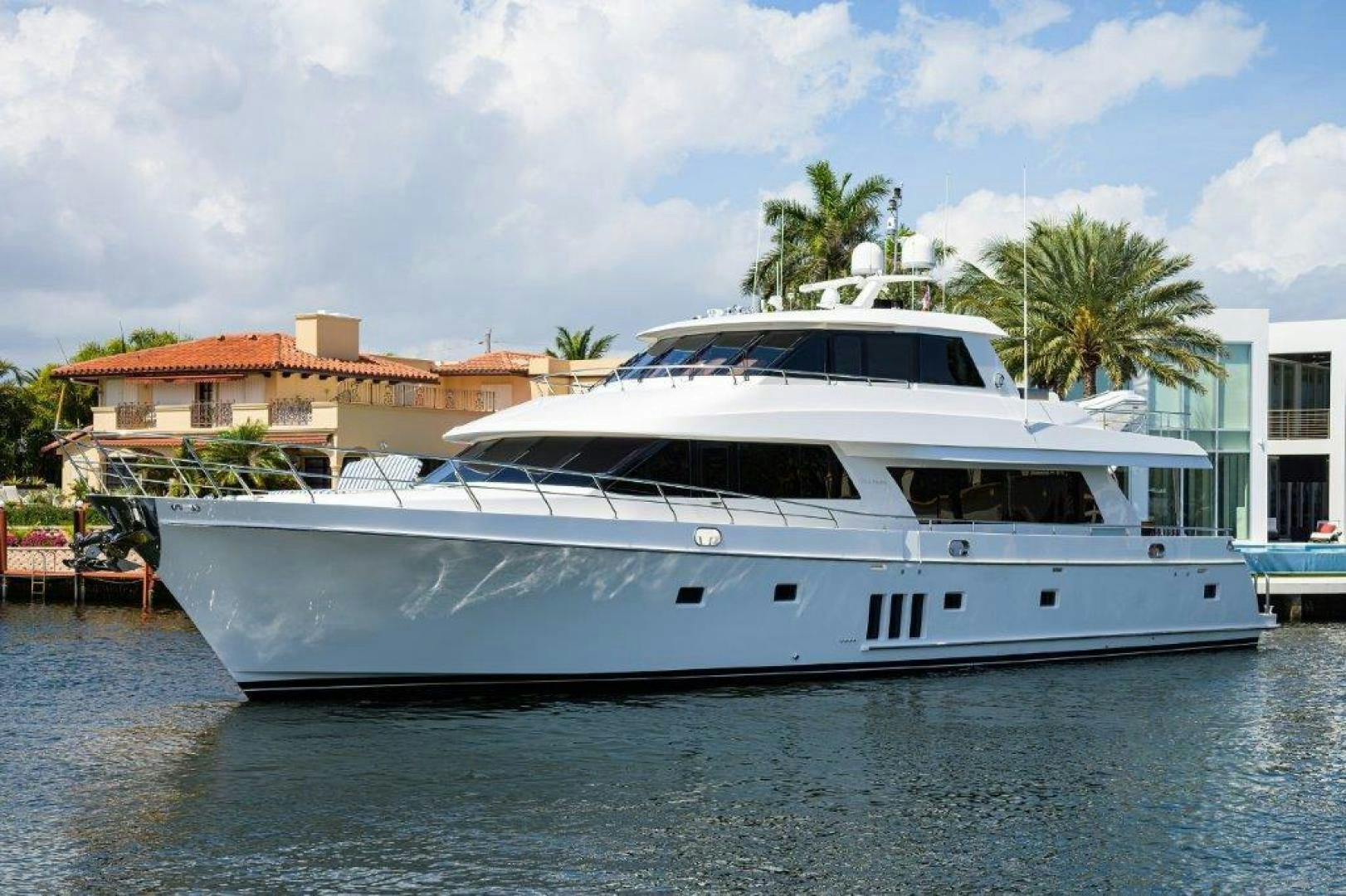 a white yacht in a harbor aboard AMAZING GRACE Yacht for Sale