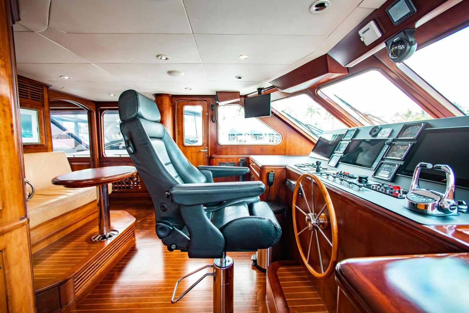 a room with a car and a table and chairs aboard DRIVEN Yacht for Sale