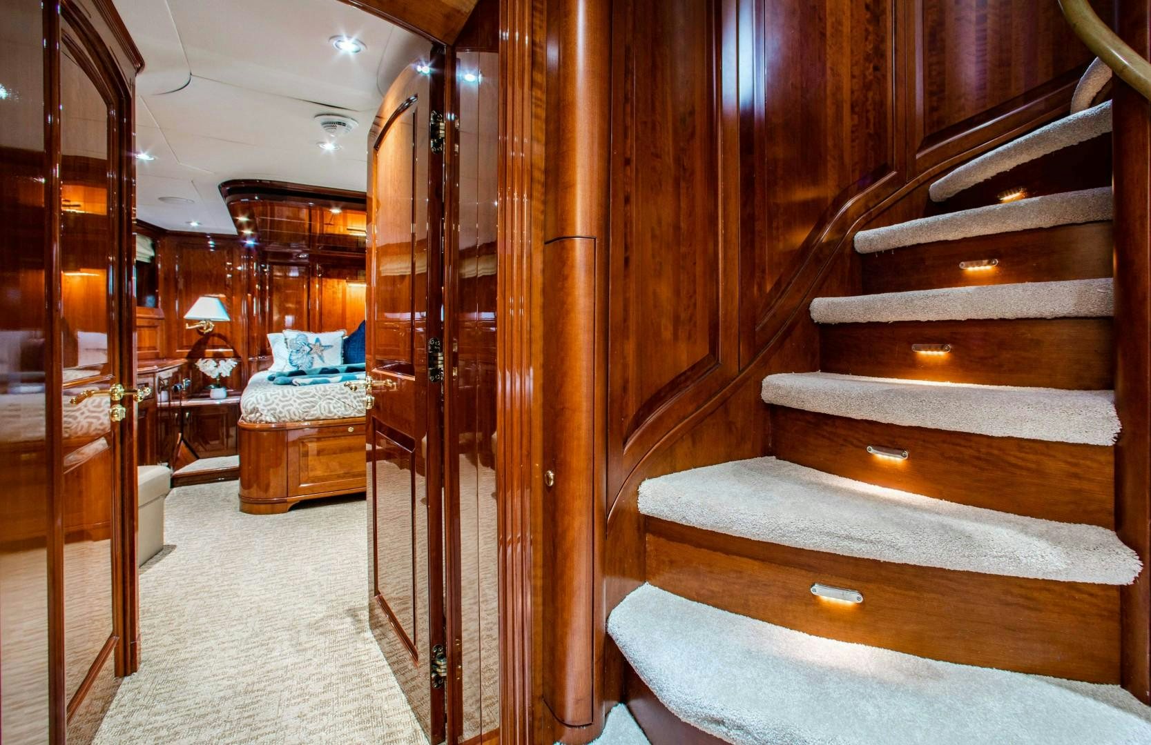a room with wooden furniture aboard DRIVEN Yacht for Sale