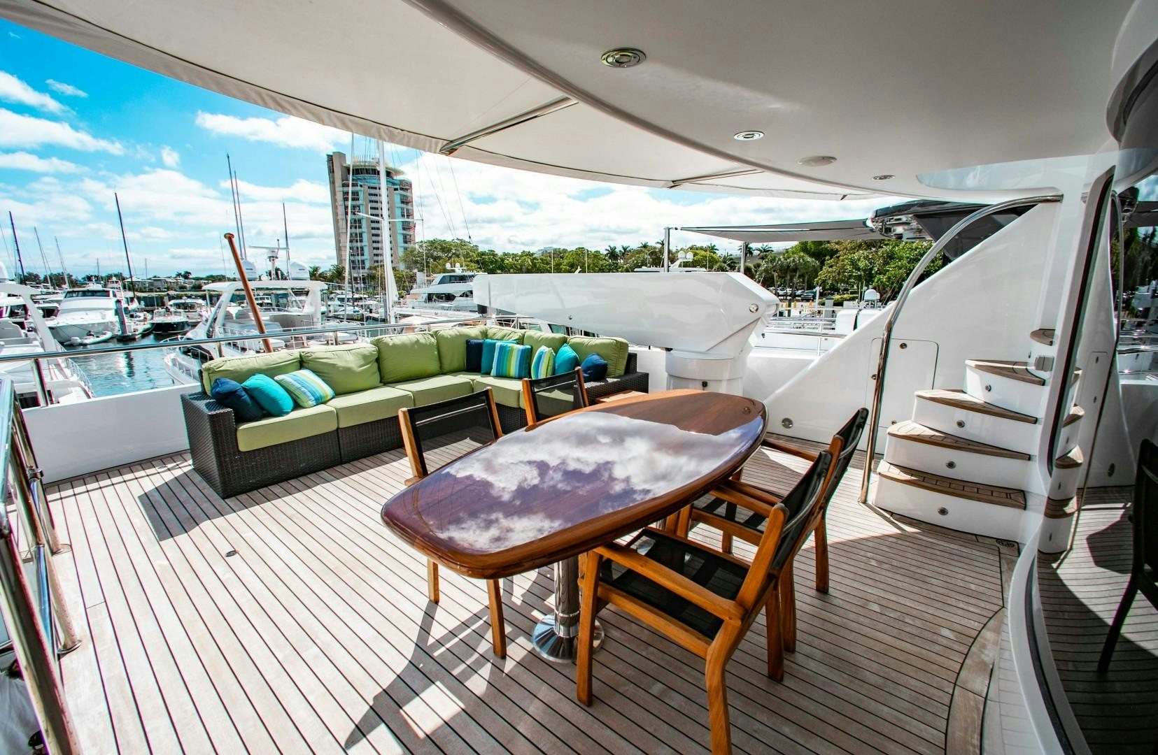 a deck with a table and chairs on it aboard DRIVEN Yacht for Sale