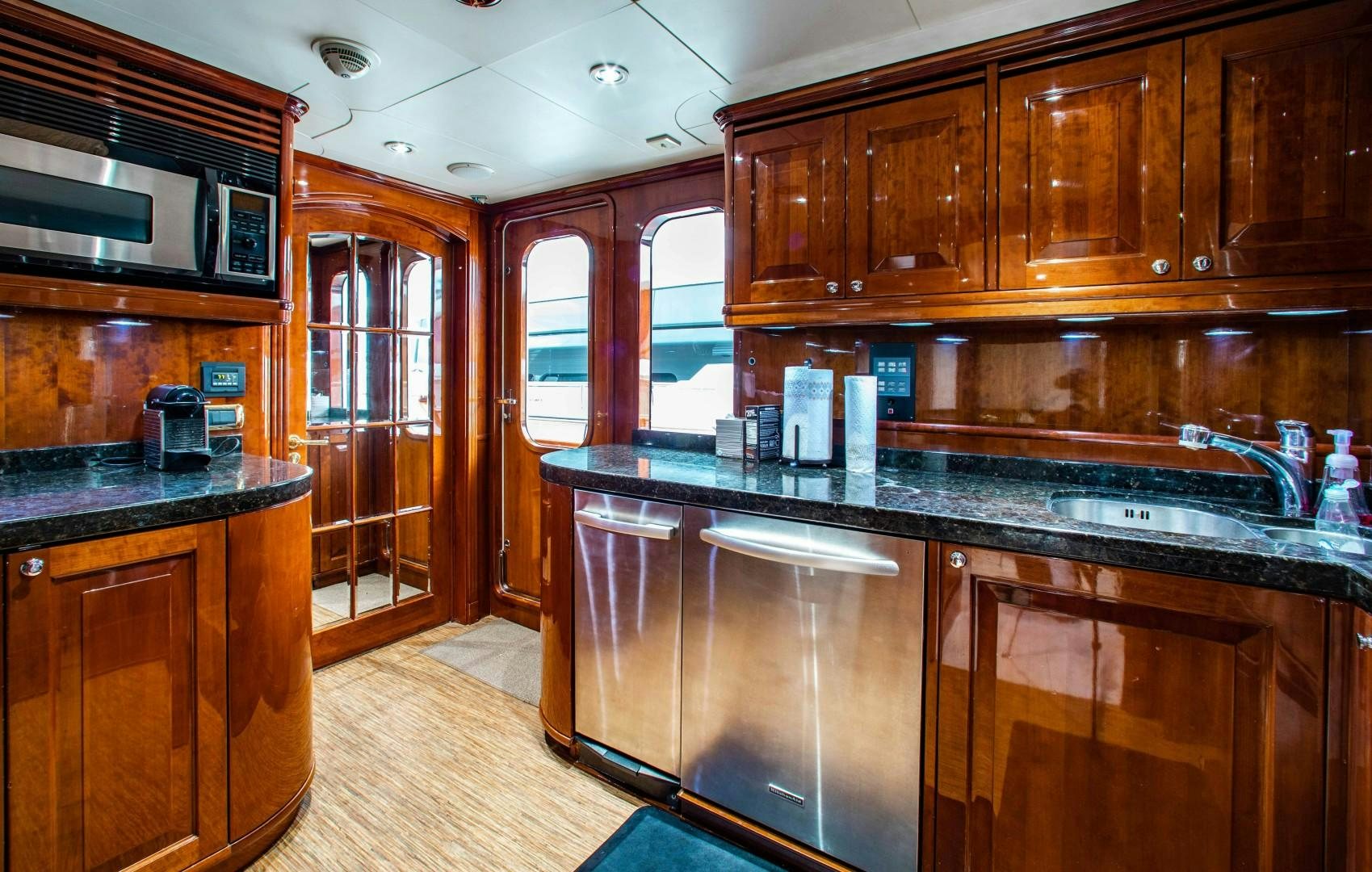 a kitchen with wooden cabinets aboard DRIVEN Yacht for Sale