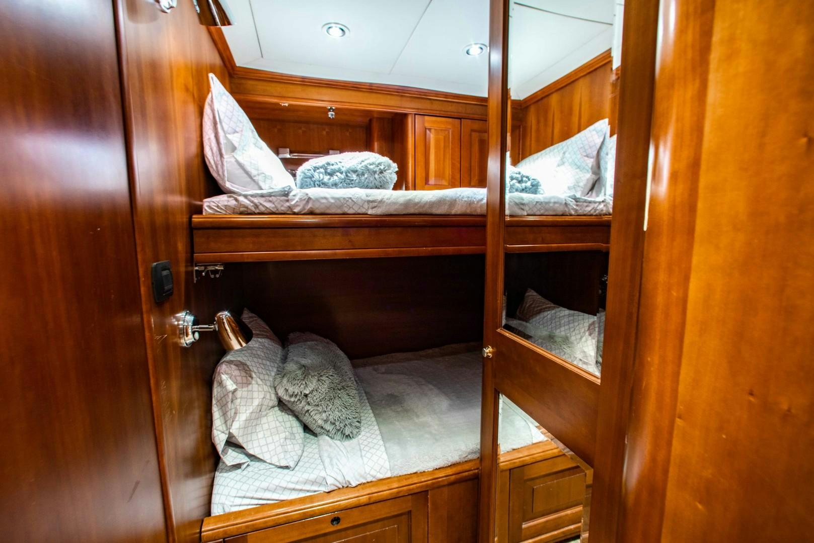 a bed with a towel on it aboard DRIVEN Yacht for Sale