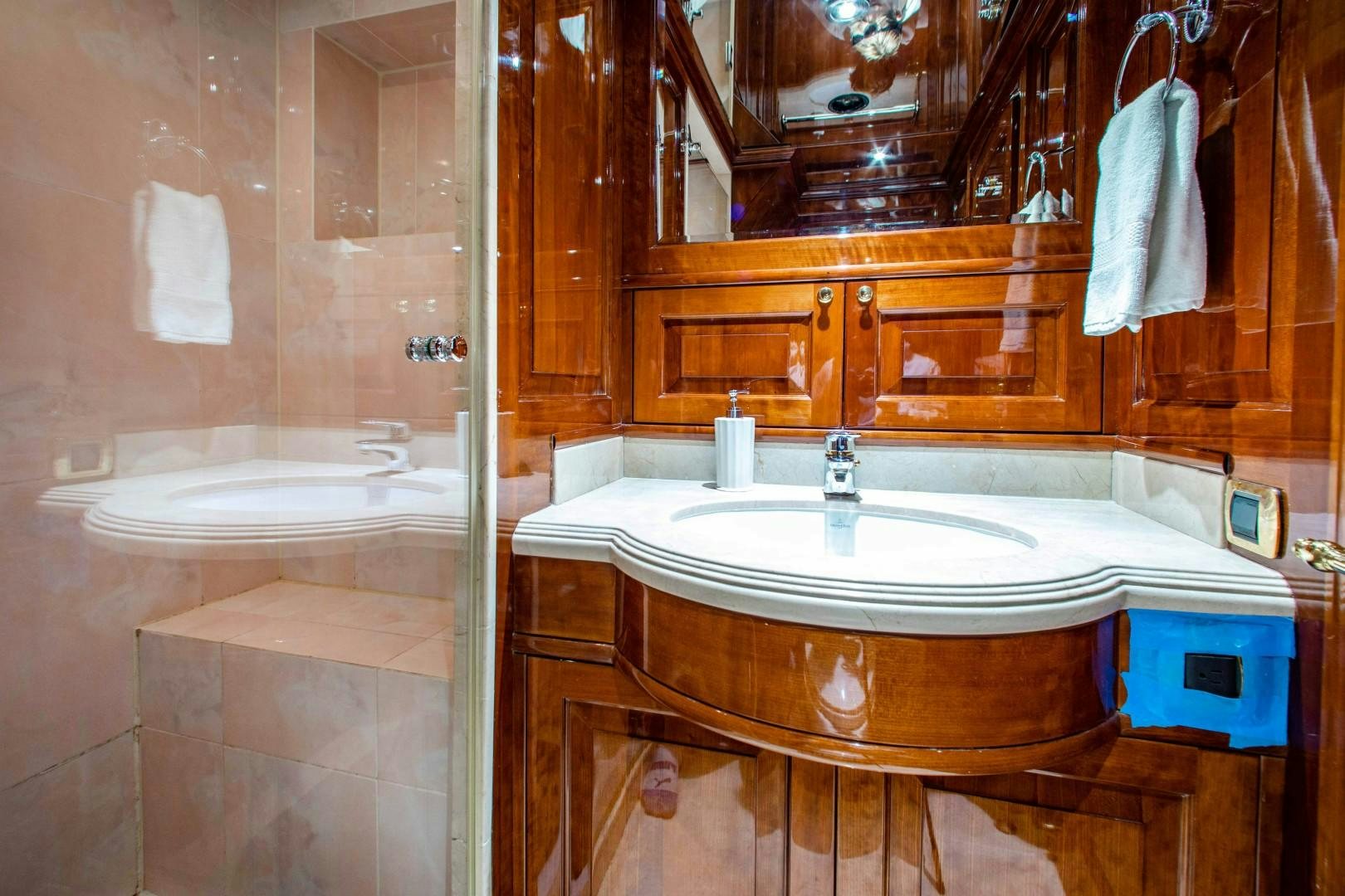 a bathroom with a tub sink and mirror aboard DRIVEN Yacht for Sale