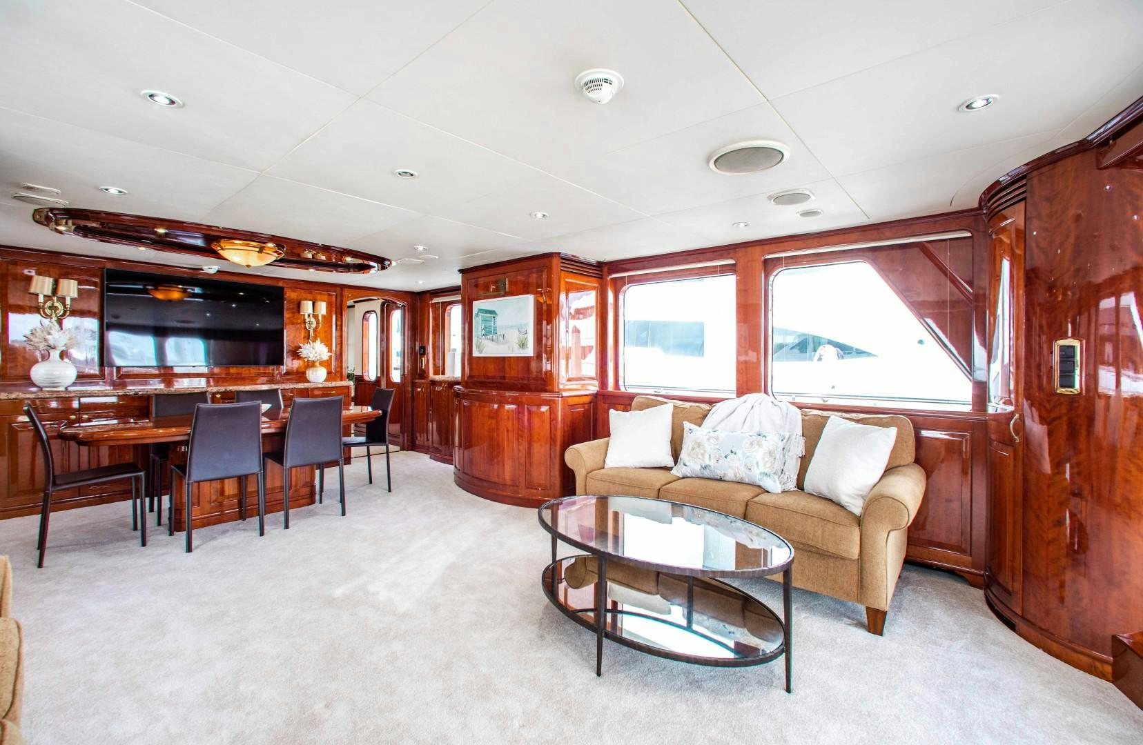 a living room with a couch and a table aboard DRIVEN Yacht for Sale