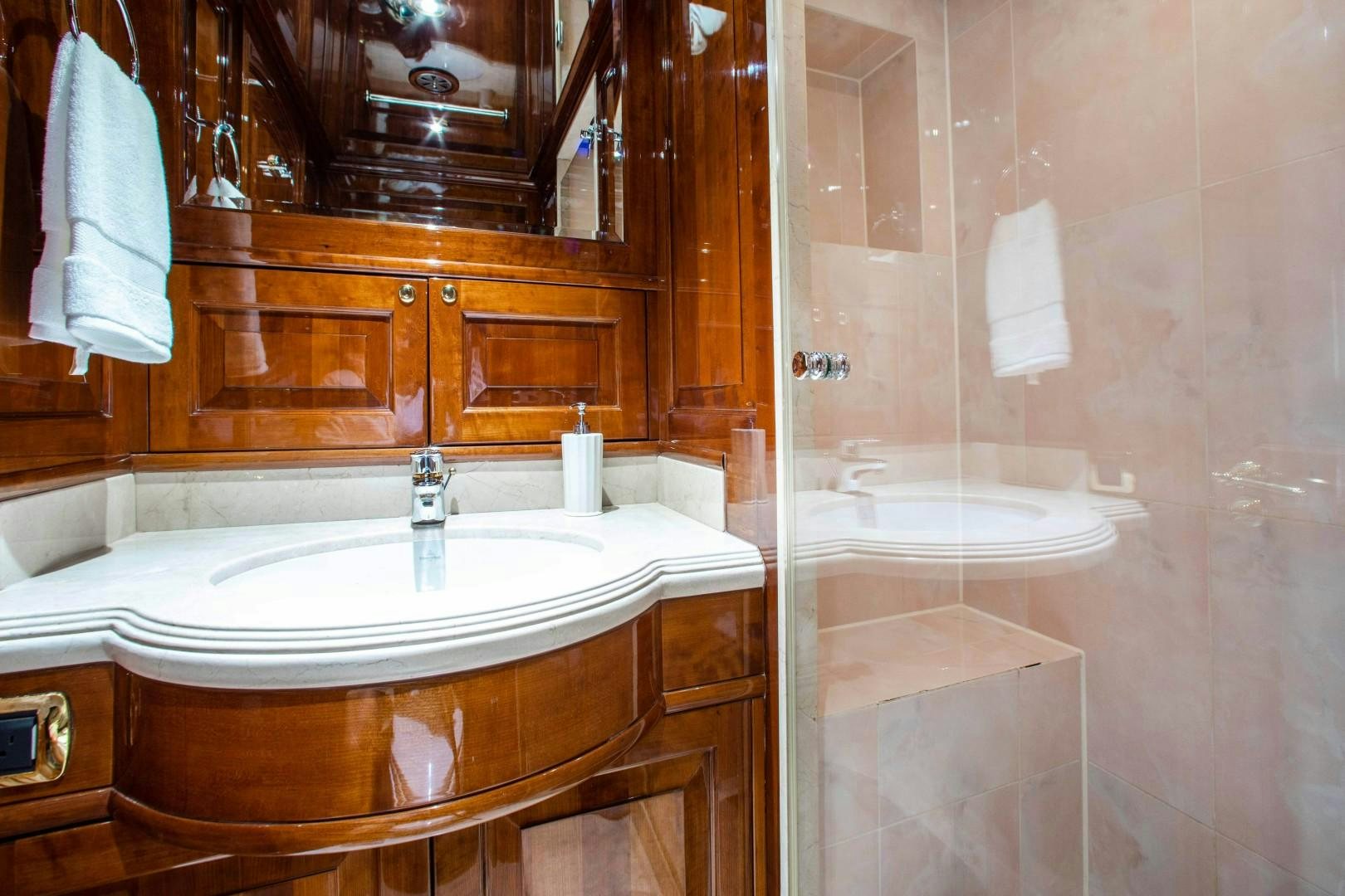 a bathroom with a bathtub and sink aboard DRIVEN Yacht for Sale