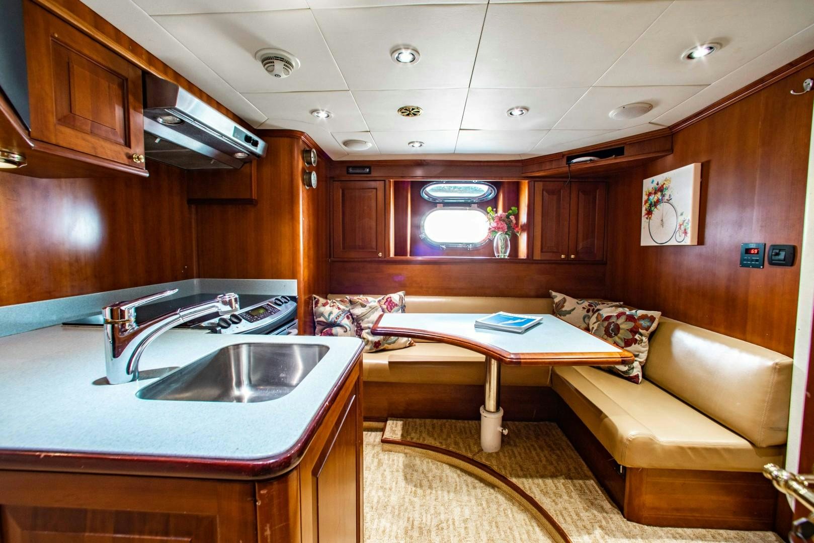 a living room with a kitchen and a bar aboard DRIVEN Yacht for Sale