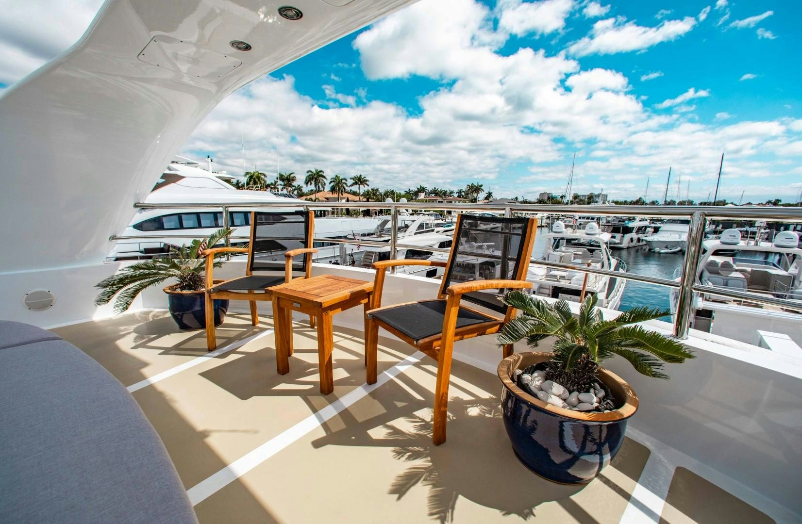 a table and chairs on a balcony aboard DRIVEN Yacht for Sale