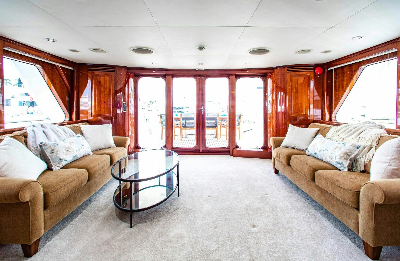 a living room with a table and couches aboard DRIVEN Yacht for Sale