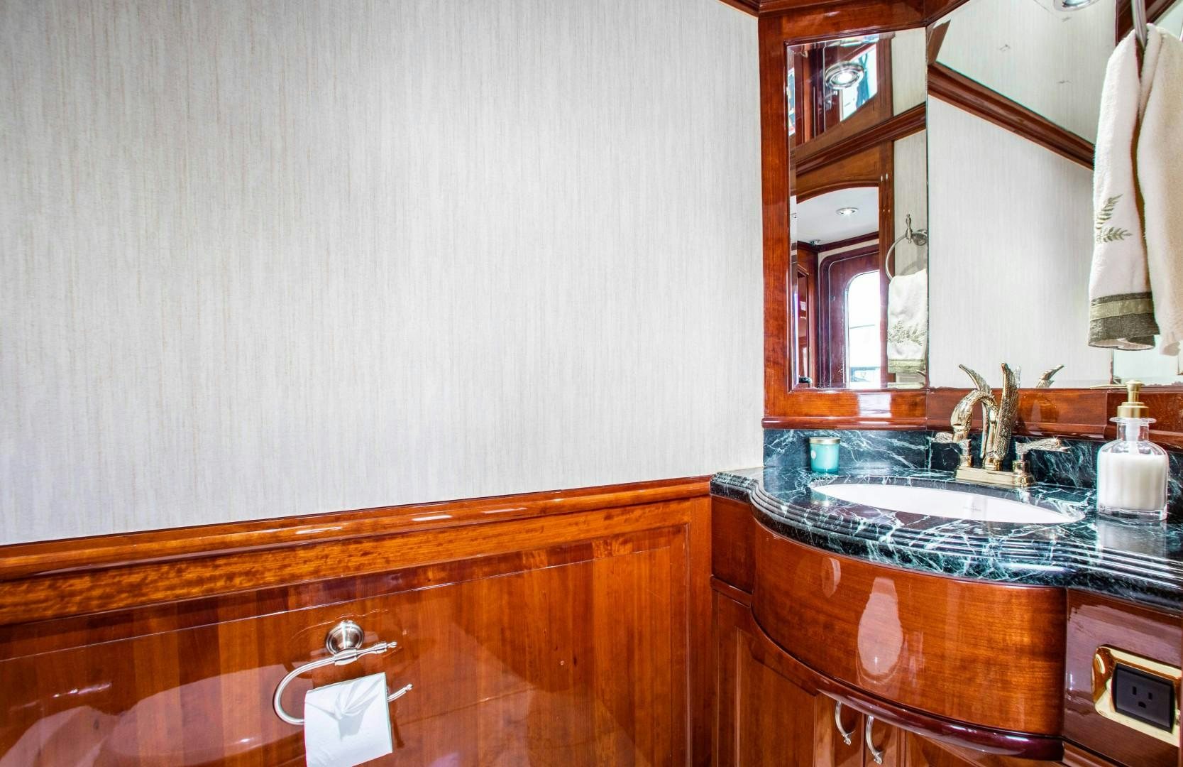 a bathroom with a sink and a mirror aboard DRIVEN Yacht for Sale