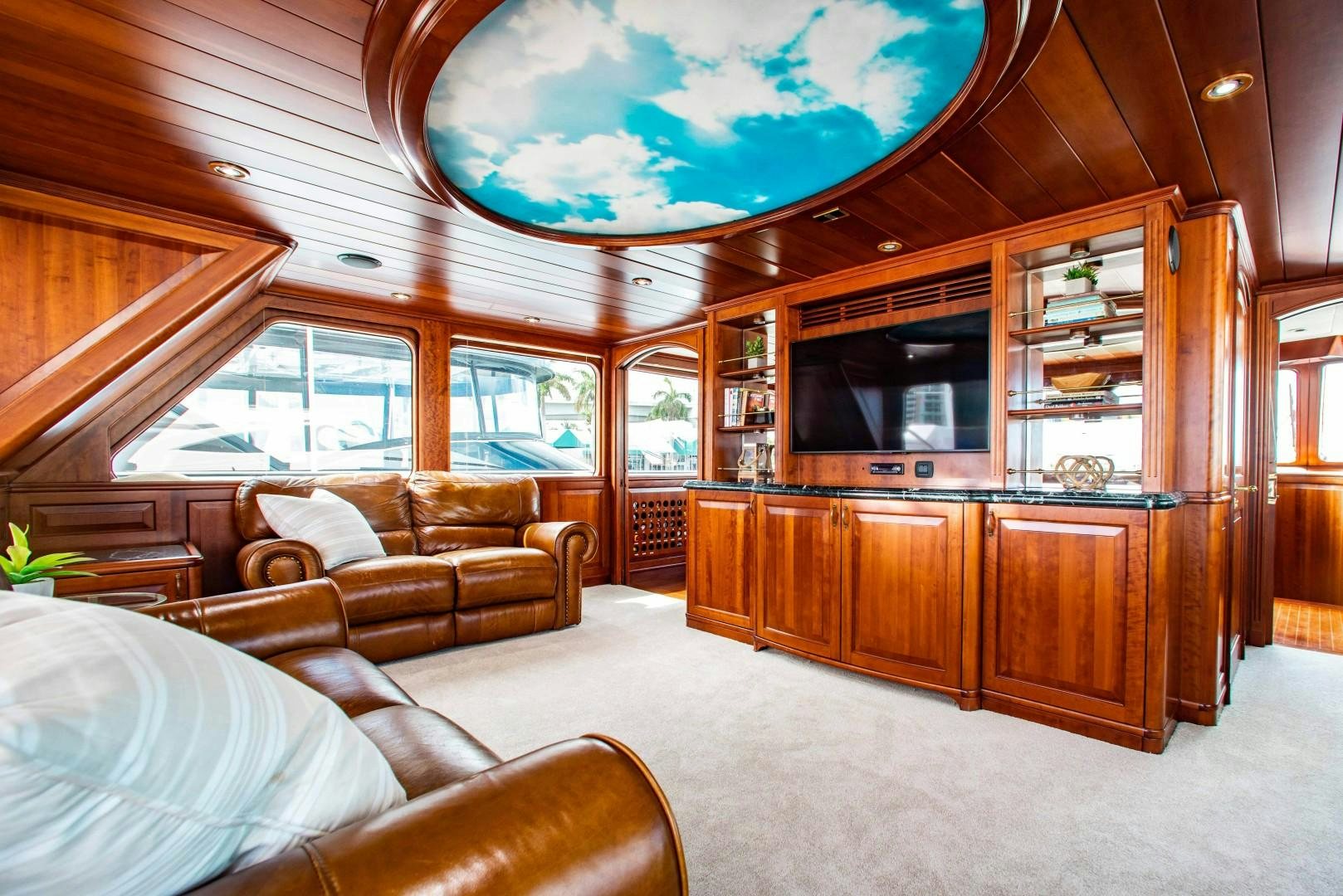 a living room with wood furniture aboard DRIVEN Yacht for Sale