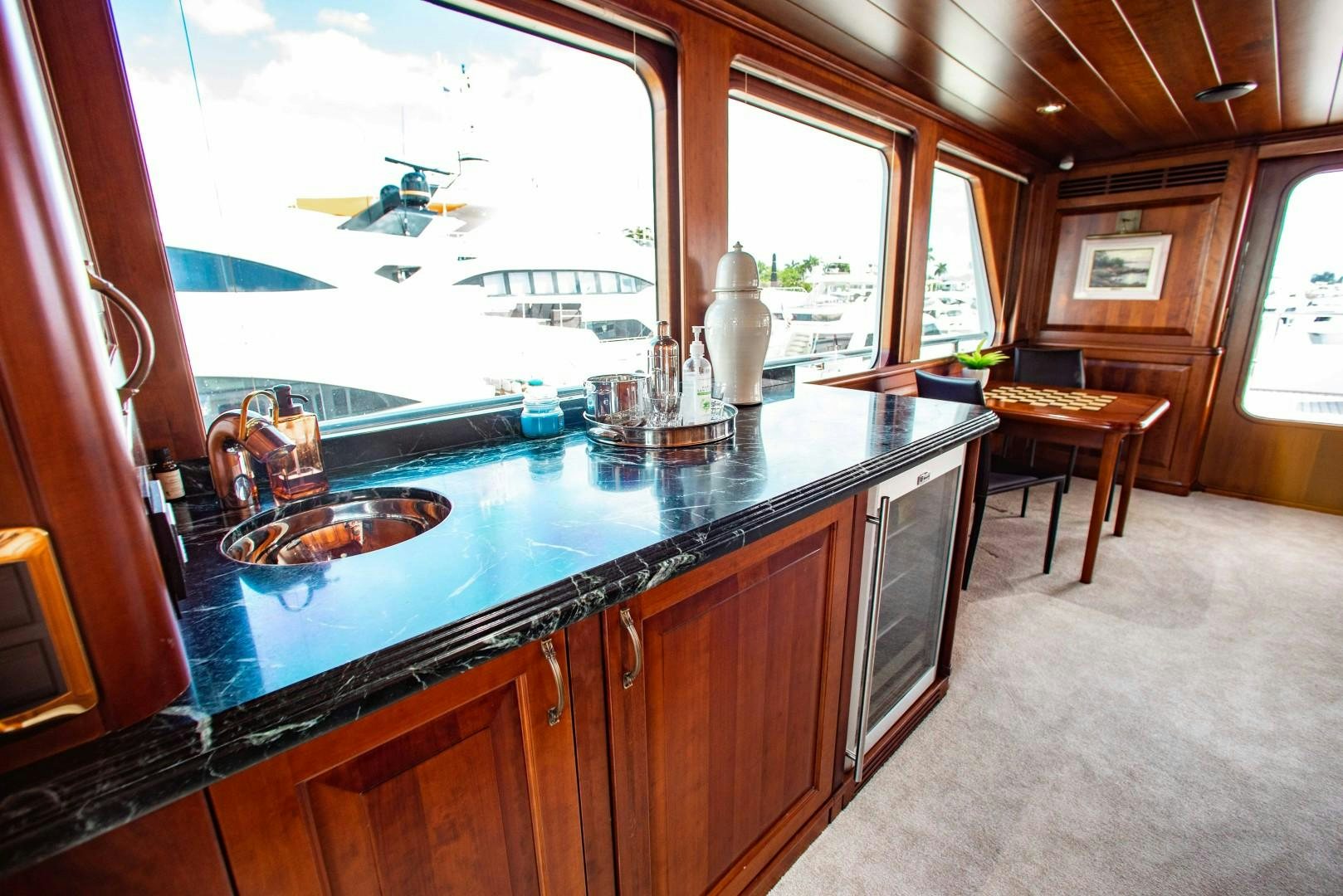 a kitchen with a large window aboard DRIVEN Yacht for Sale