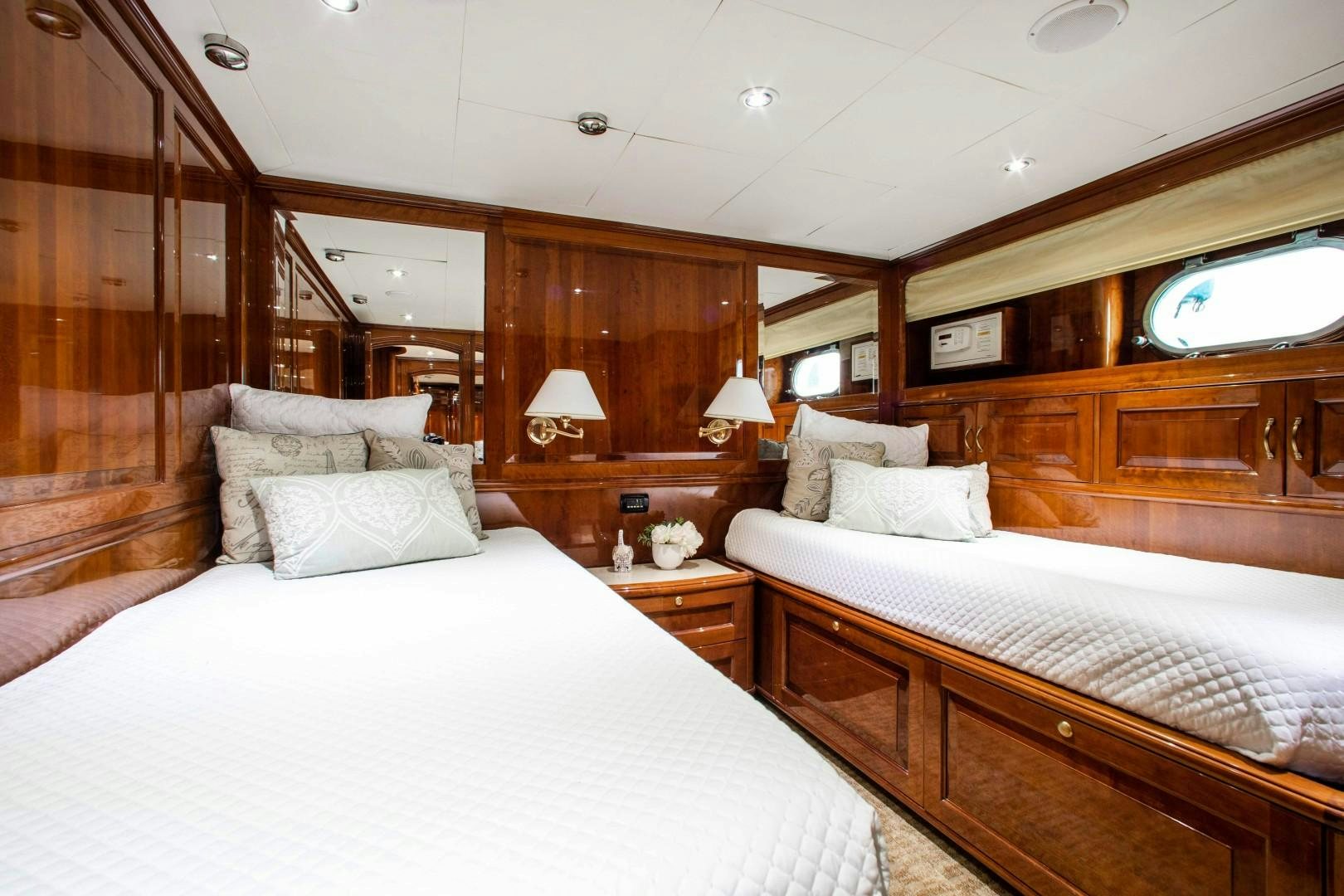 a room with a bed and a mirror aboard DRIVEN Yacht for Sale