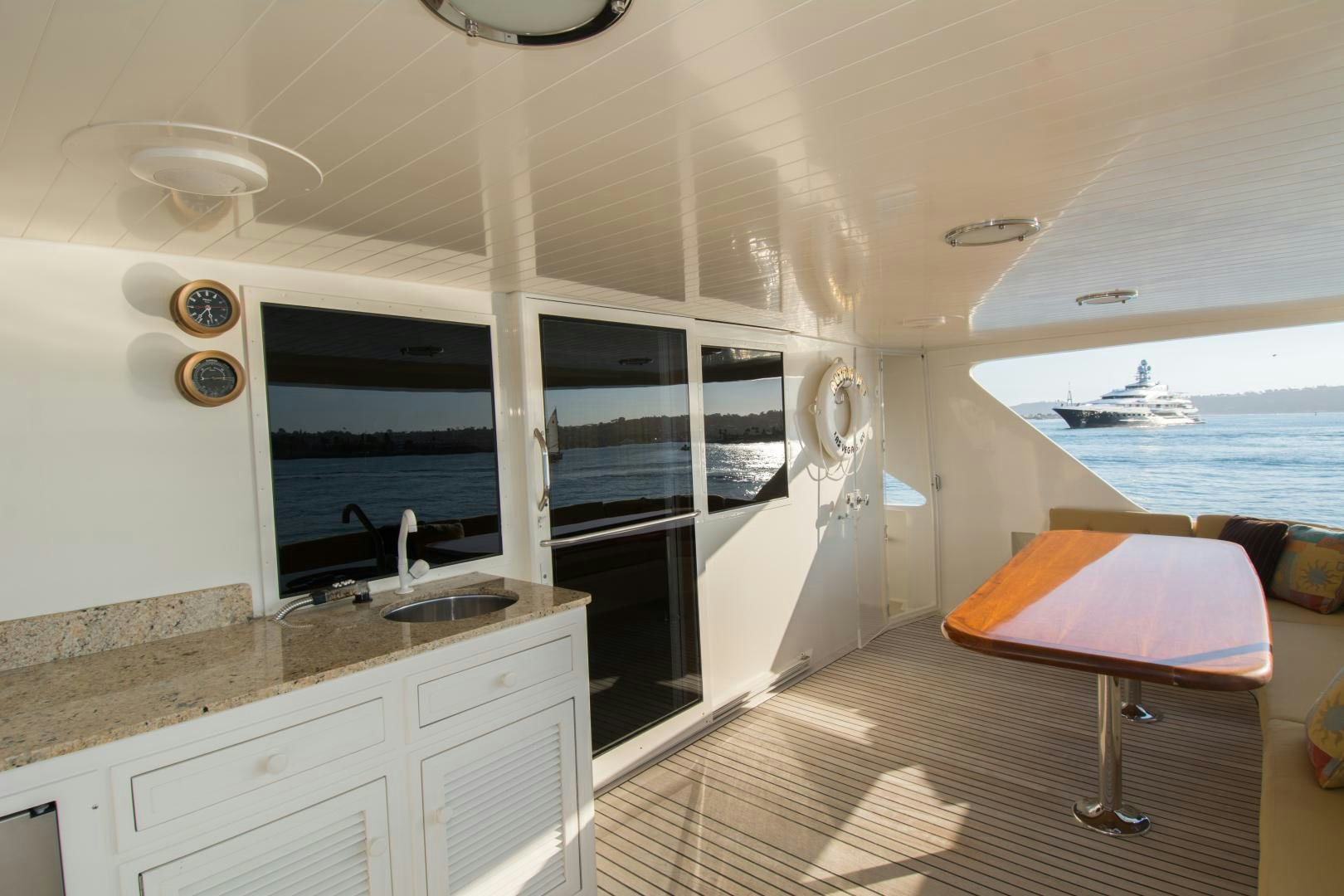 a boat with a table and chairs aboard WHISKEY DAWN Yacht for Sale