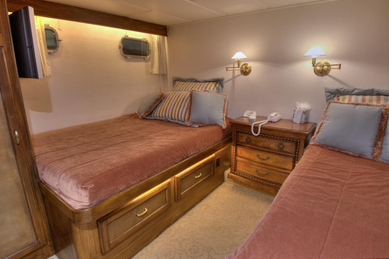 a bedroom with a bed and a dresser aboard WHISKEY DAWN Yacht for Sale